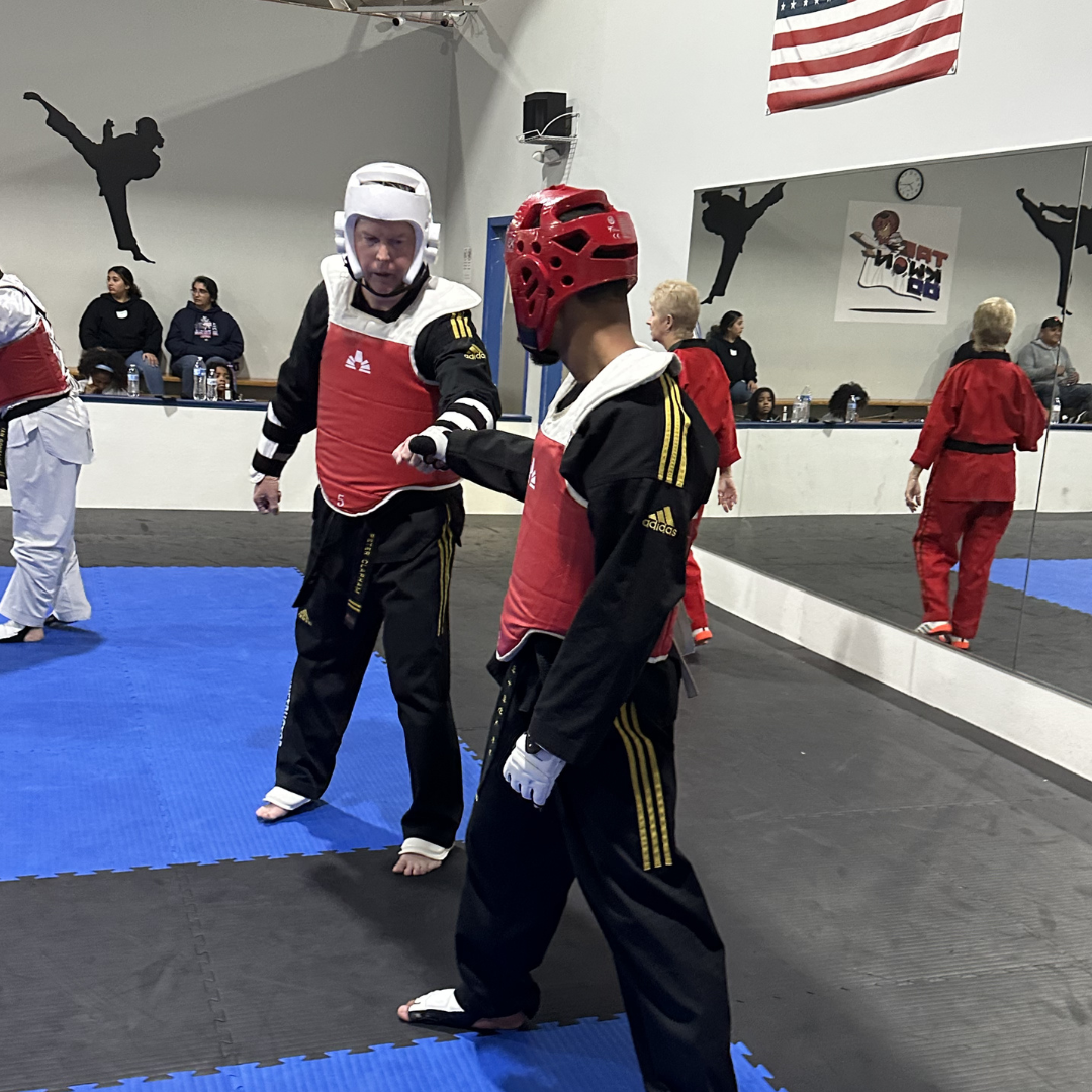 Adult Taekwondo students demonstrating sportsmanship during partner training at Tennessee Taekwondo.