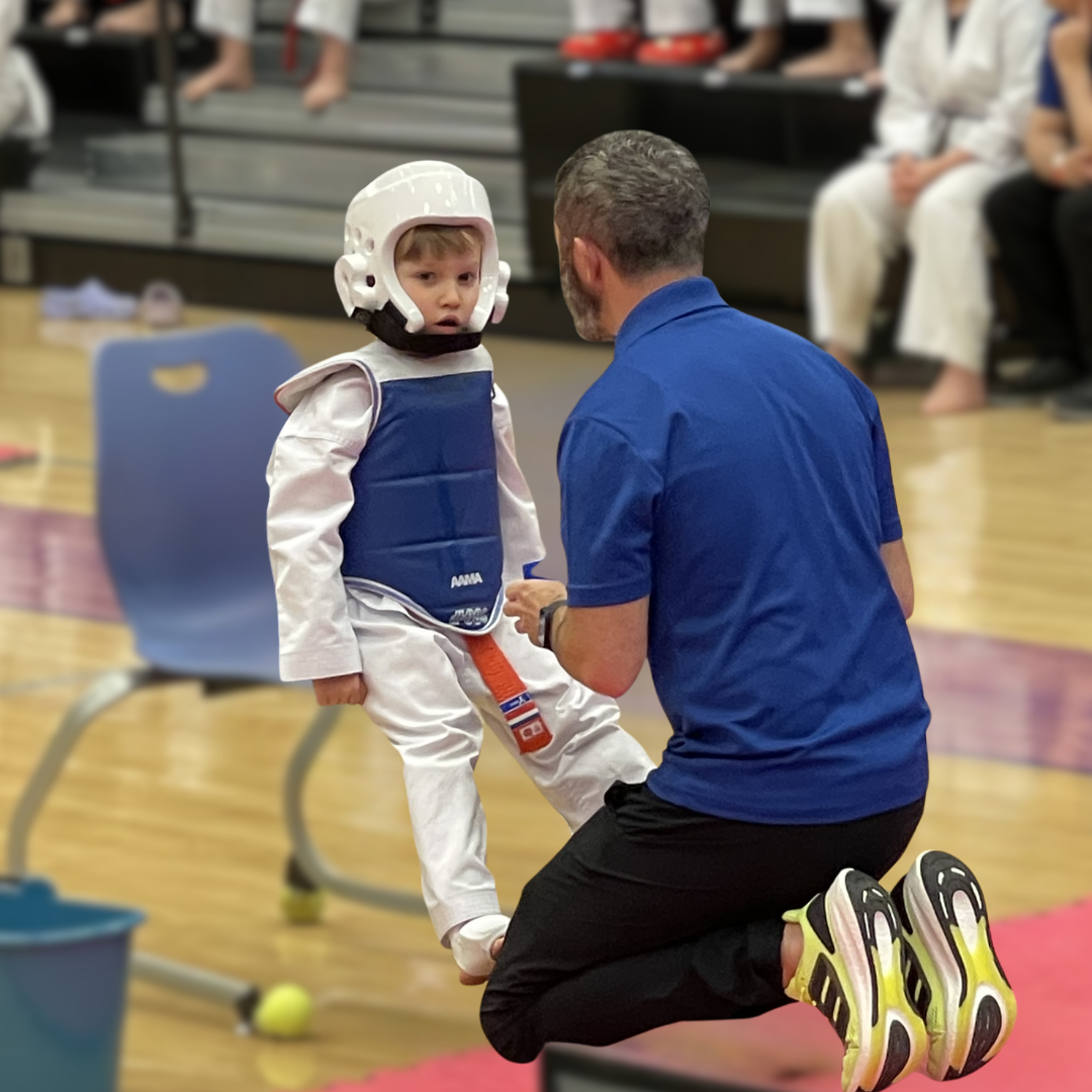 Master Dustin Sands coaching a young student before competition
