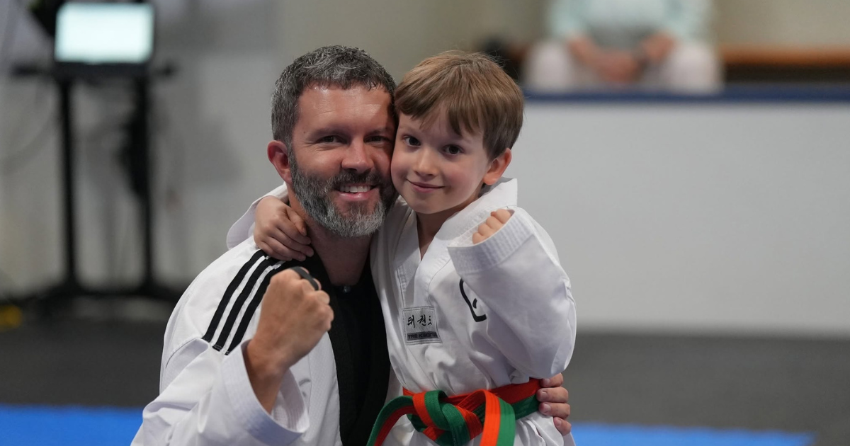 Young martial arts student celebrating with Master Dustin Sands
