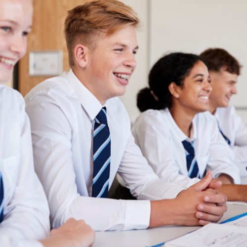 A group of young people are sitting at a table and smiling