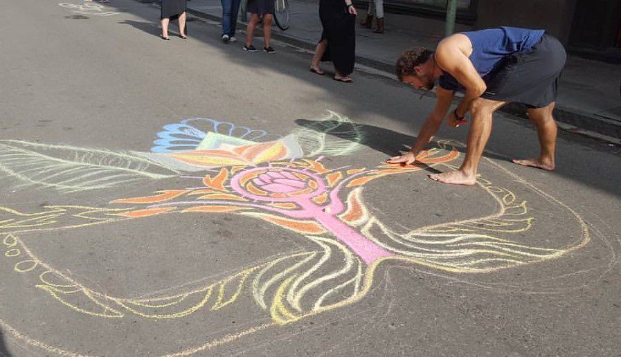 Ian Cleary blends chalk on Heartspace Art chalk art mural, entitled Feminine Mystique, created in New Orleans for the Women's March.