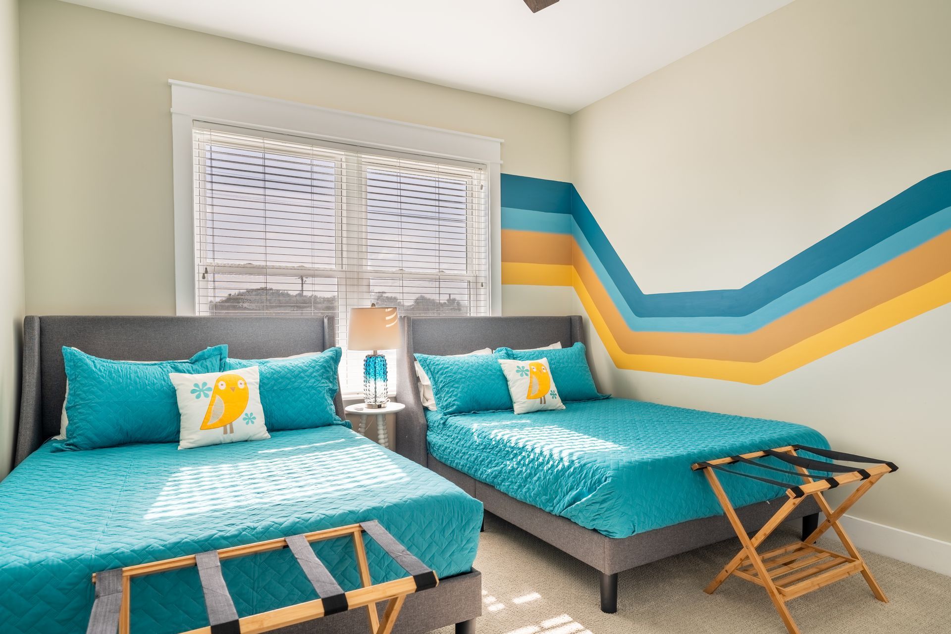 Funky retro lines accent wall that spans multiple walls creating an an immersive wall art experience at this short term rental outside St. Augustine, Florida.