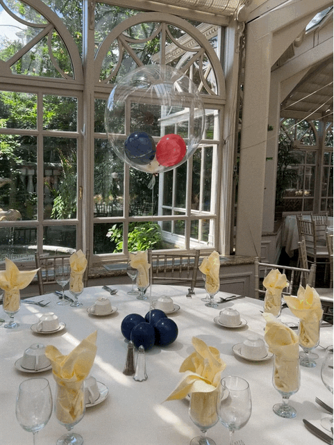 A table set for a party with balloons on it
