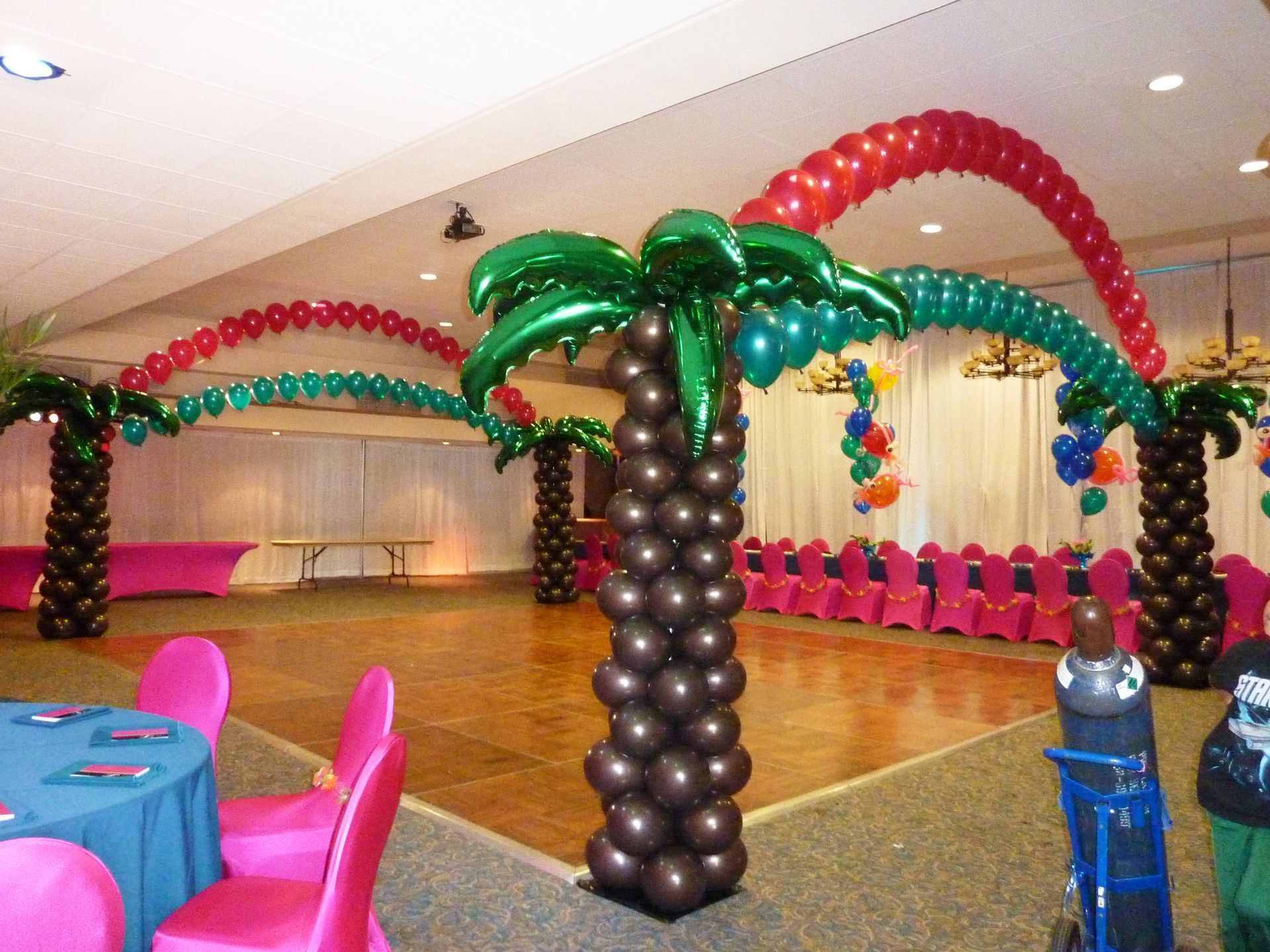 A room decorated with balloons in the shape of palm trees