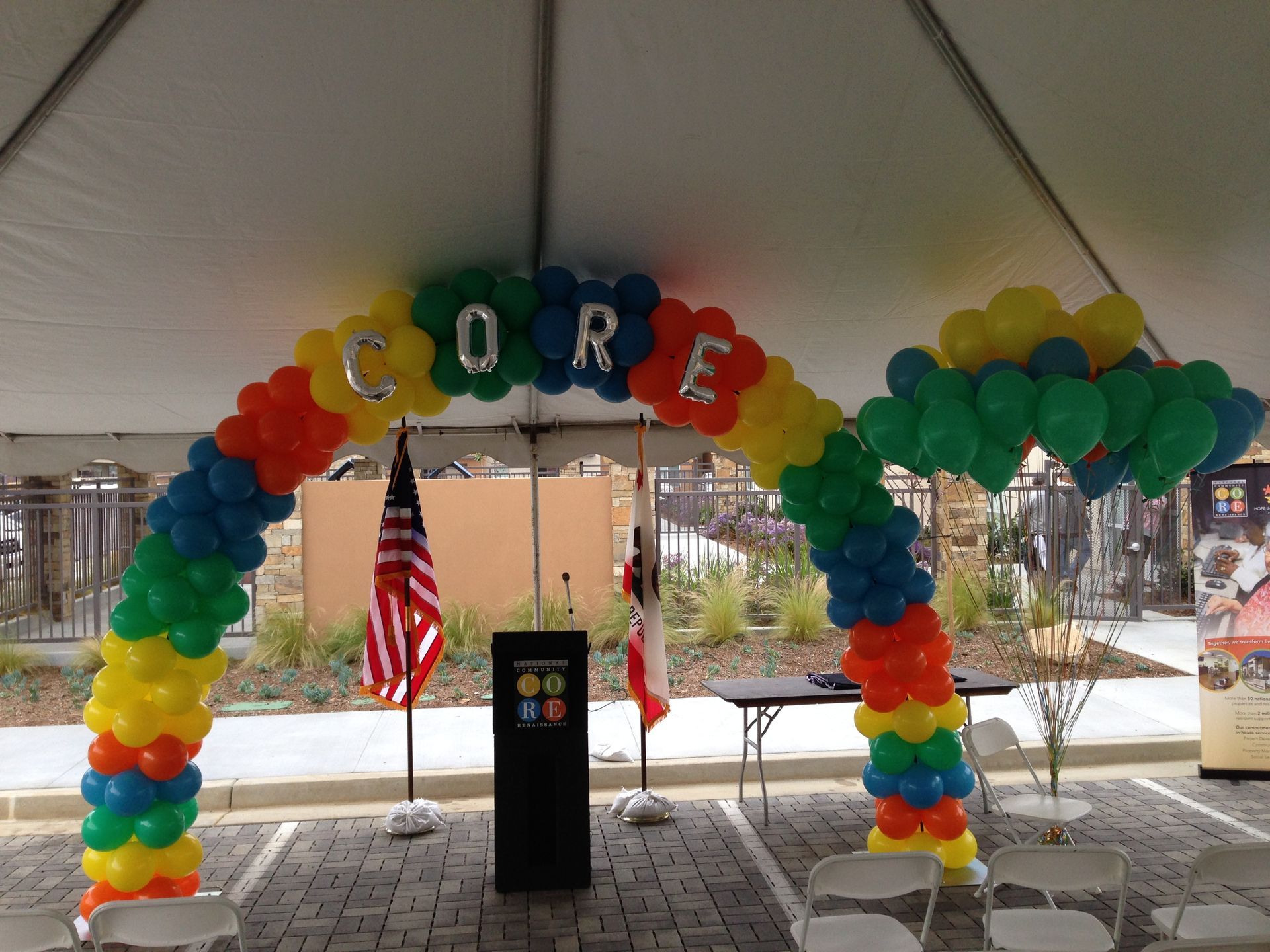 A colorful balloon arch with the word core on it