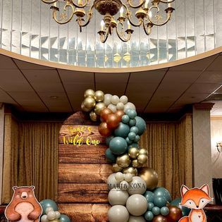 A room decorated with balloons and a wooden wall.