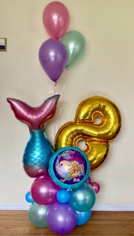 A bunch of balloons are stacked on top of each other in a room.