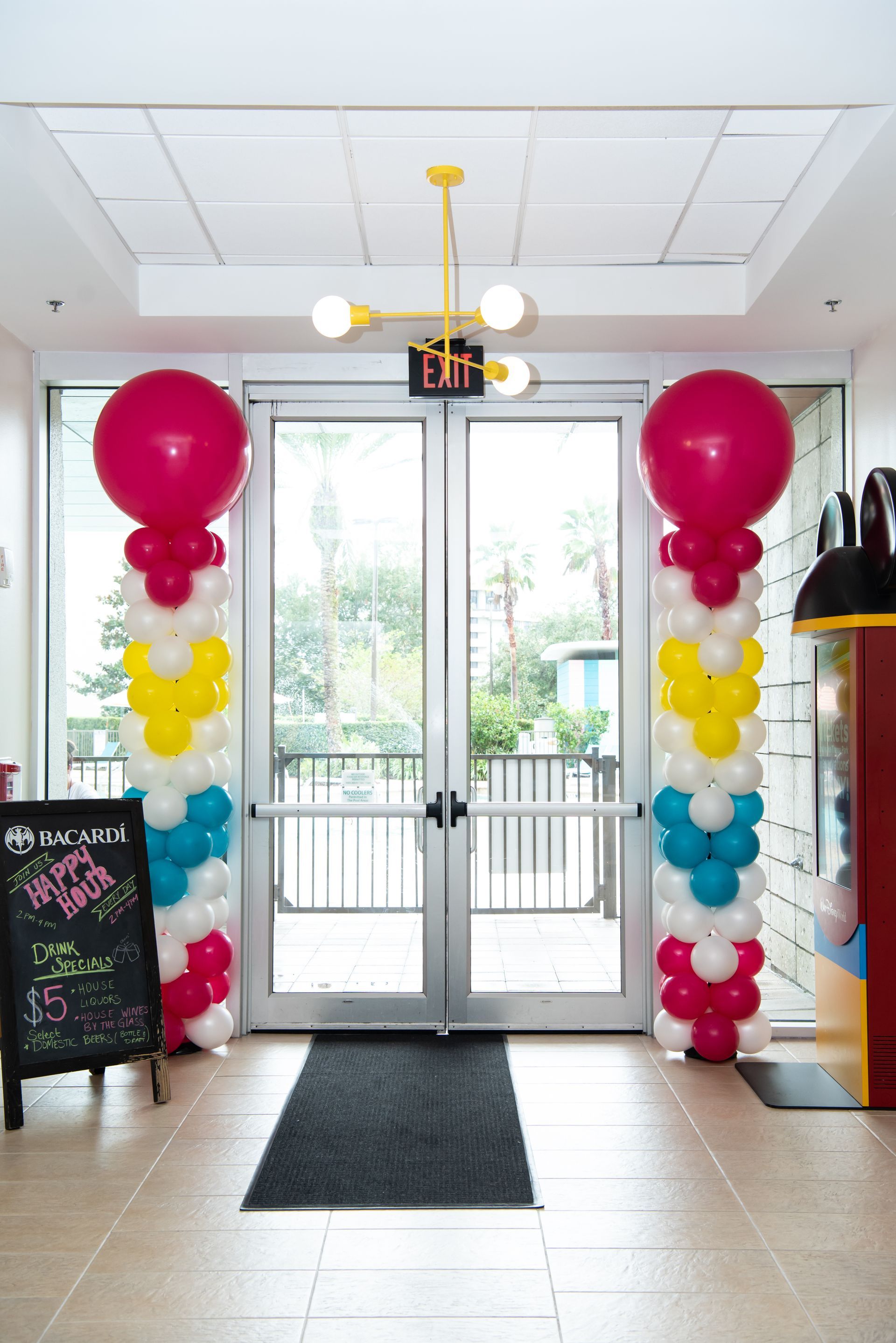 A hallway with balloons in the shape of mickey mouse