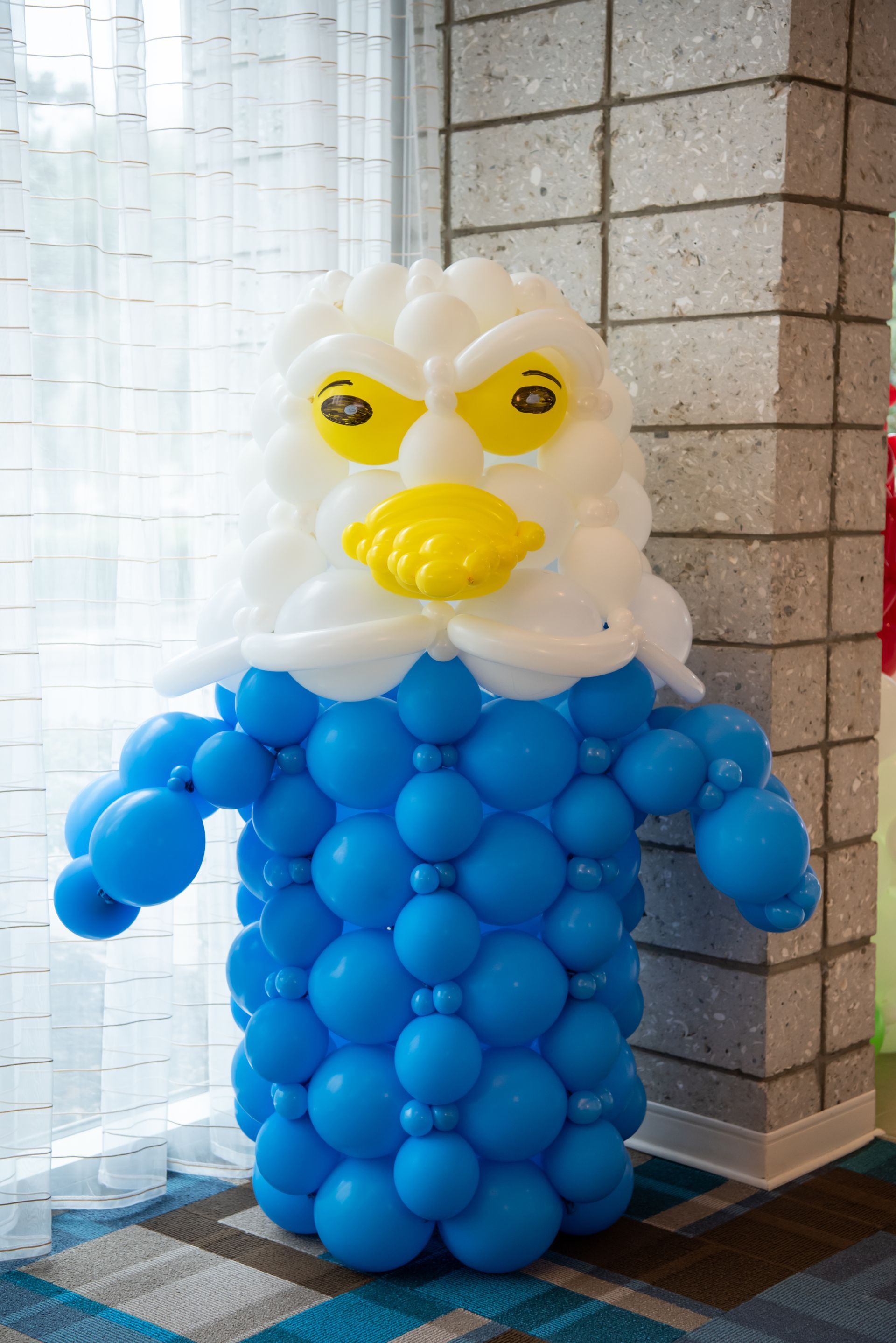 A bald eagle made out of blue and white balloons