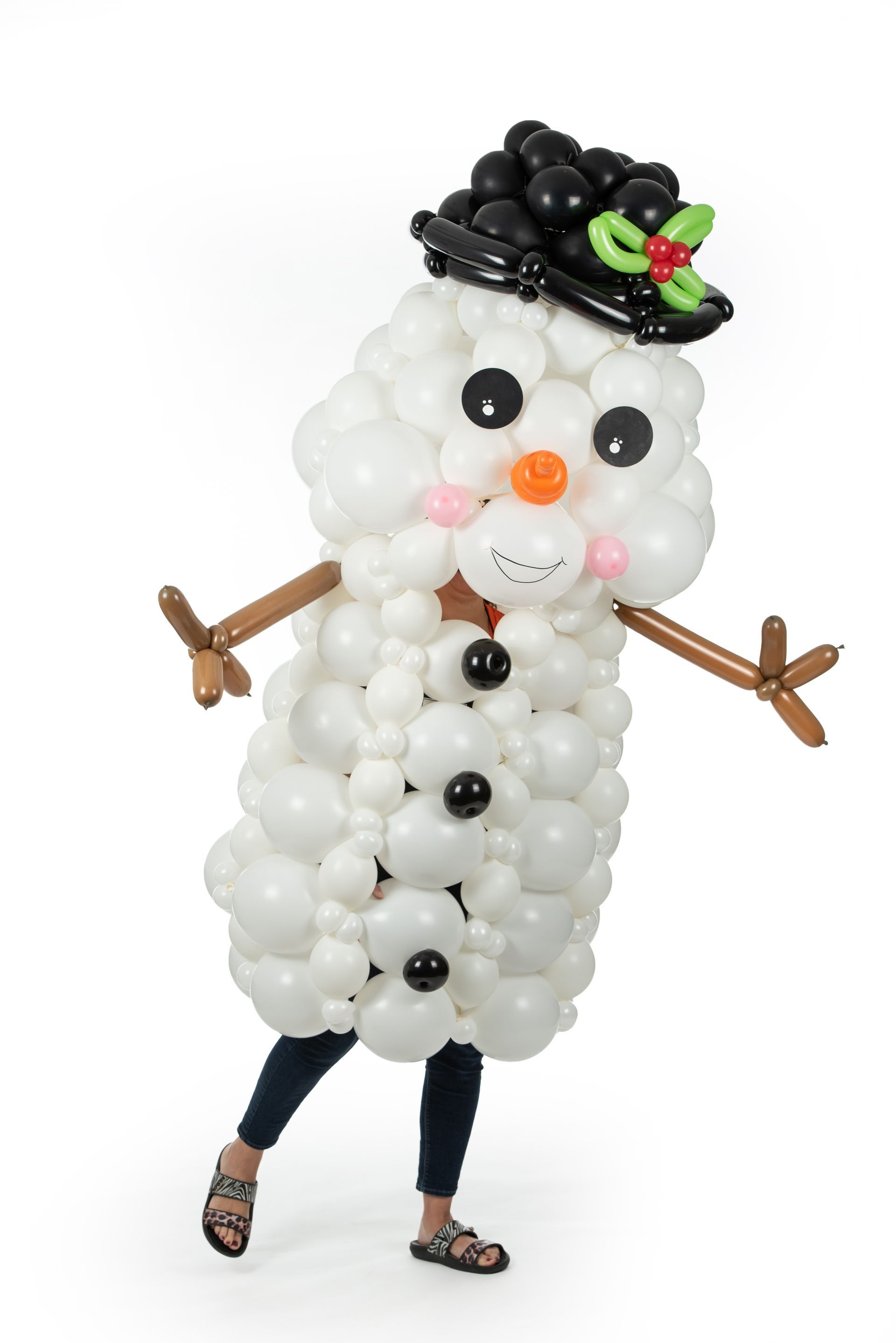 A person is dressed as a snowman made out of balloons.