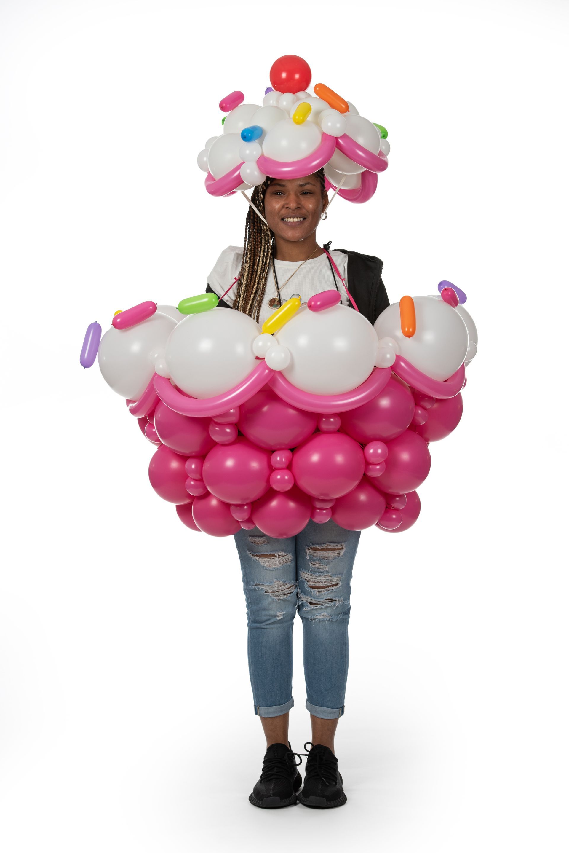 A woman is wearing a cupcake costume made of balloons.