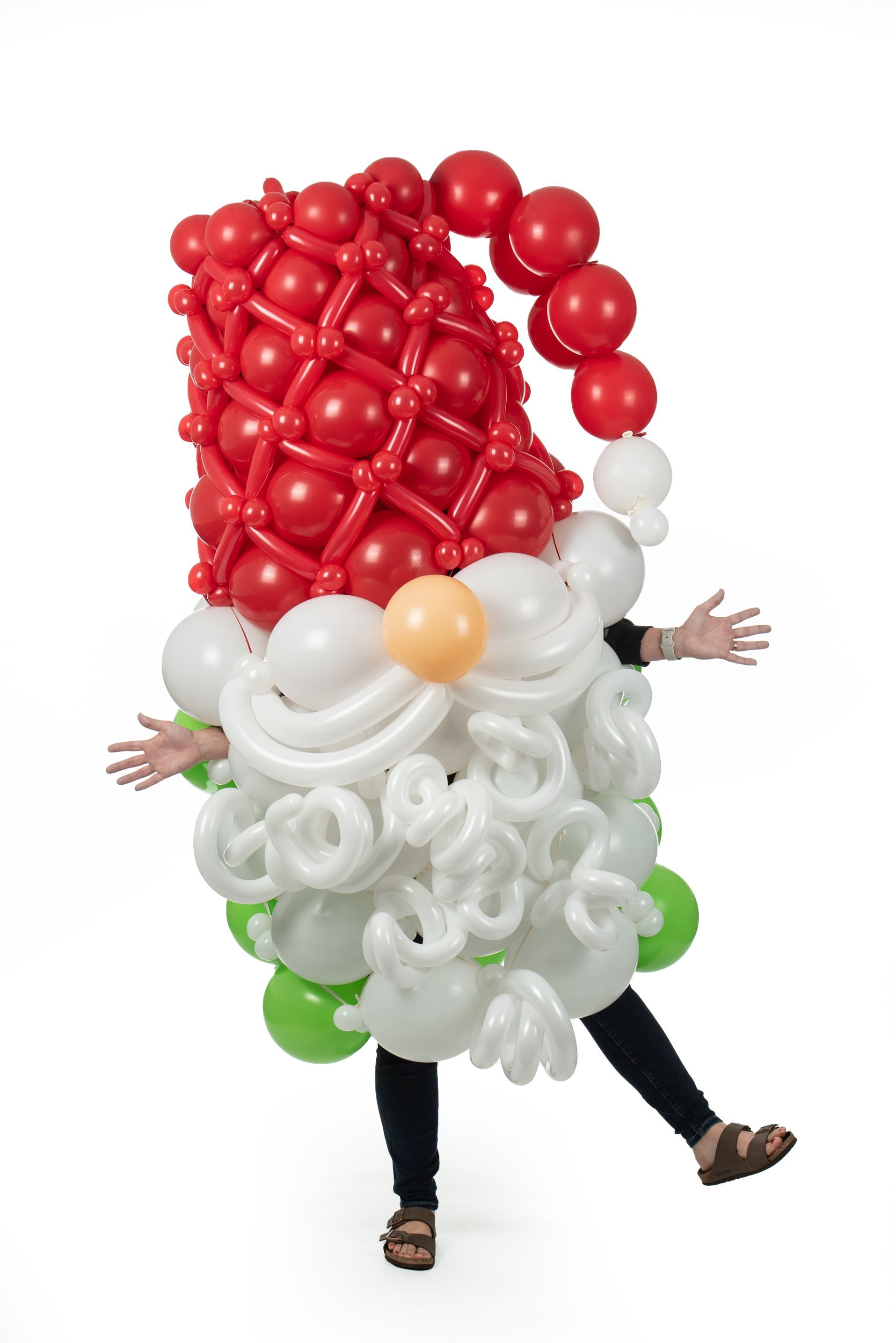 A person is dressed as a gnome made out of balloons.
