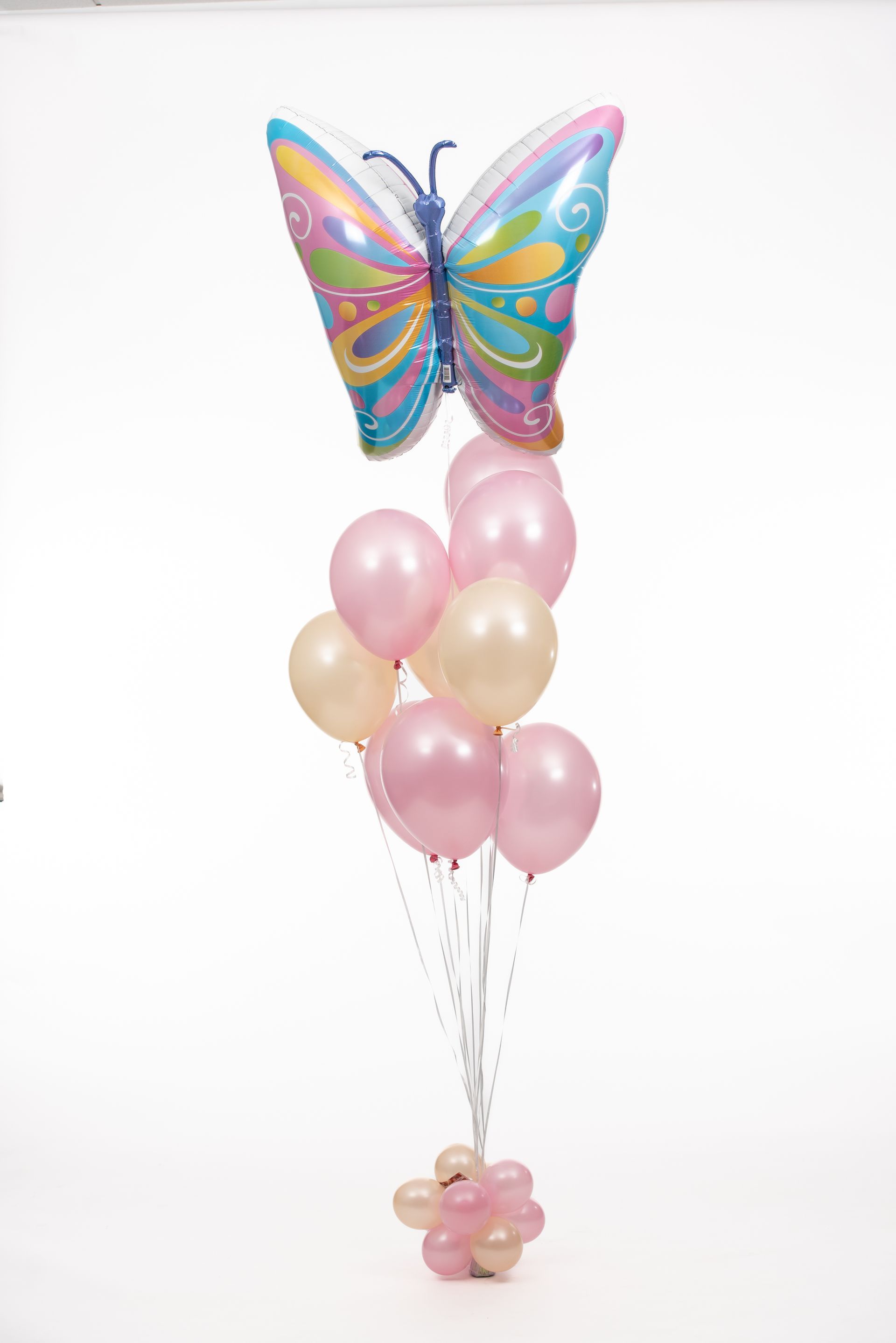 A bunch of pink and gold balloons with a butterfly balloon in the middle.