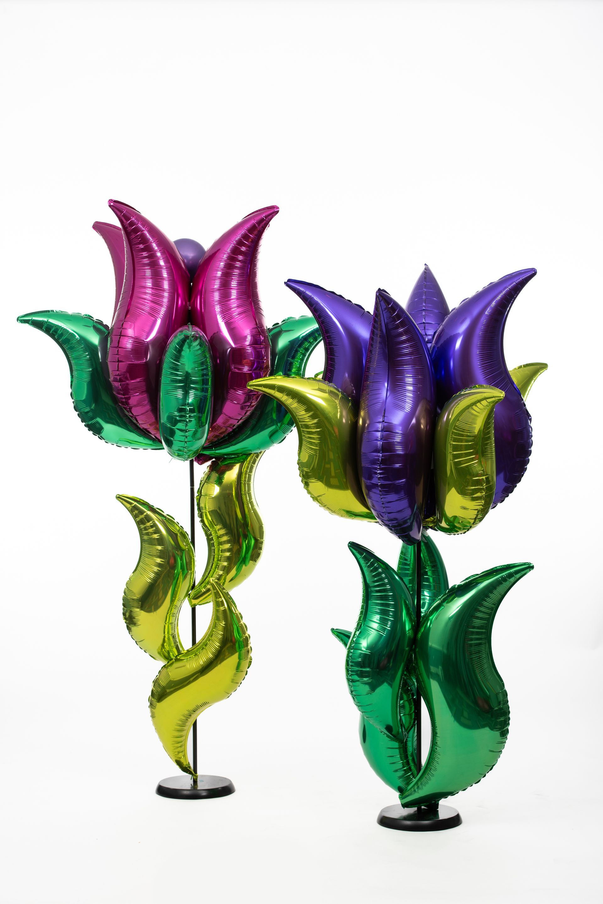 Purple and green balloons in the shape of flowers