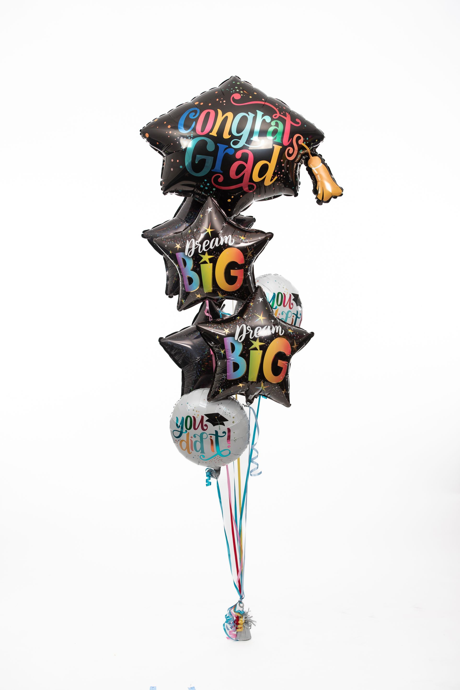 A bunch of graduation balloons on a white background.