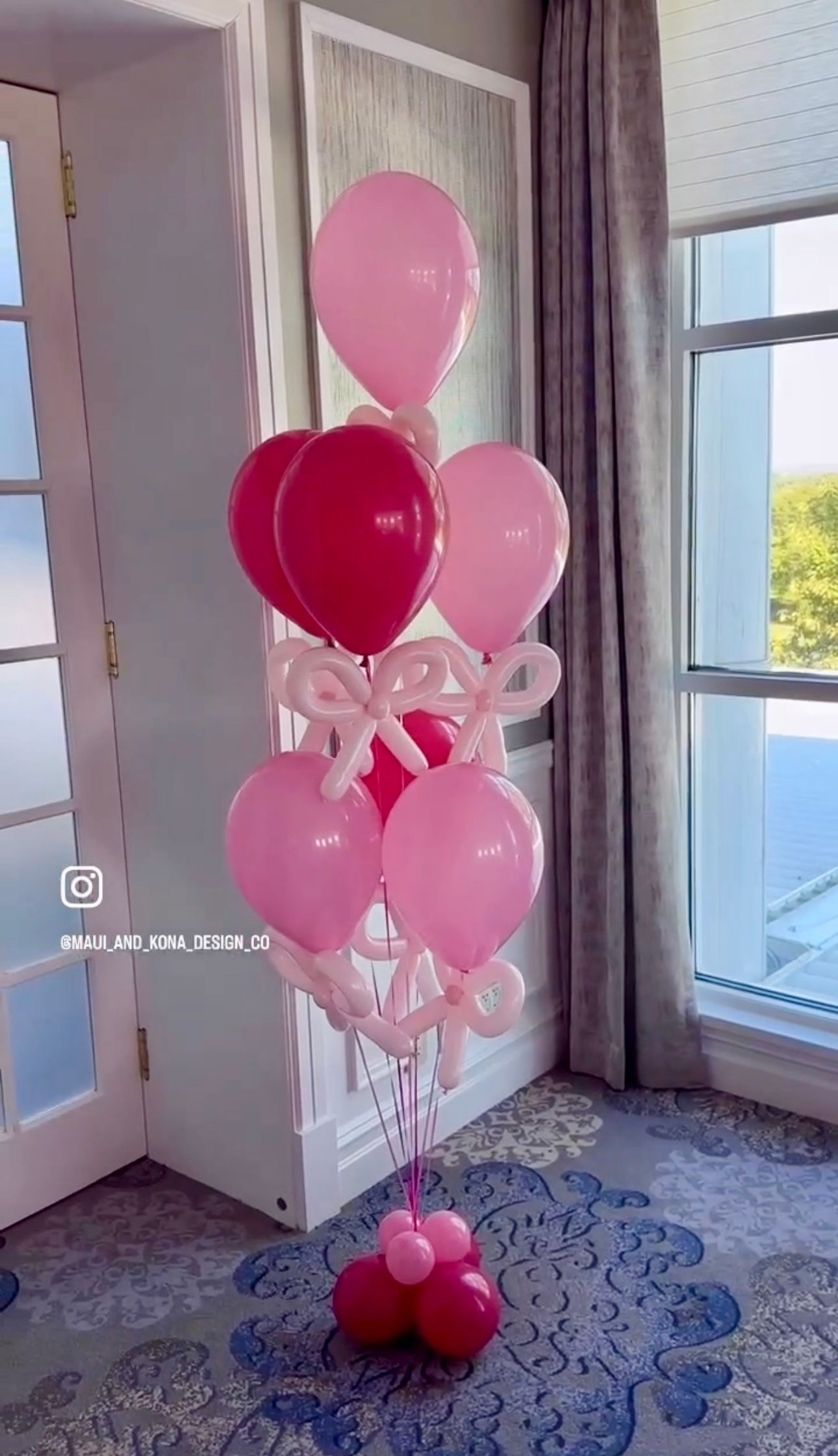 A bunch of pink and red balloons in a room
