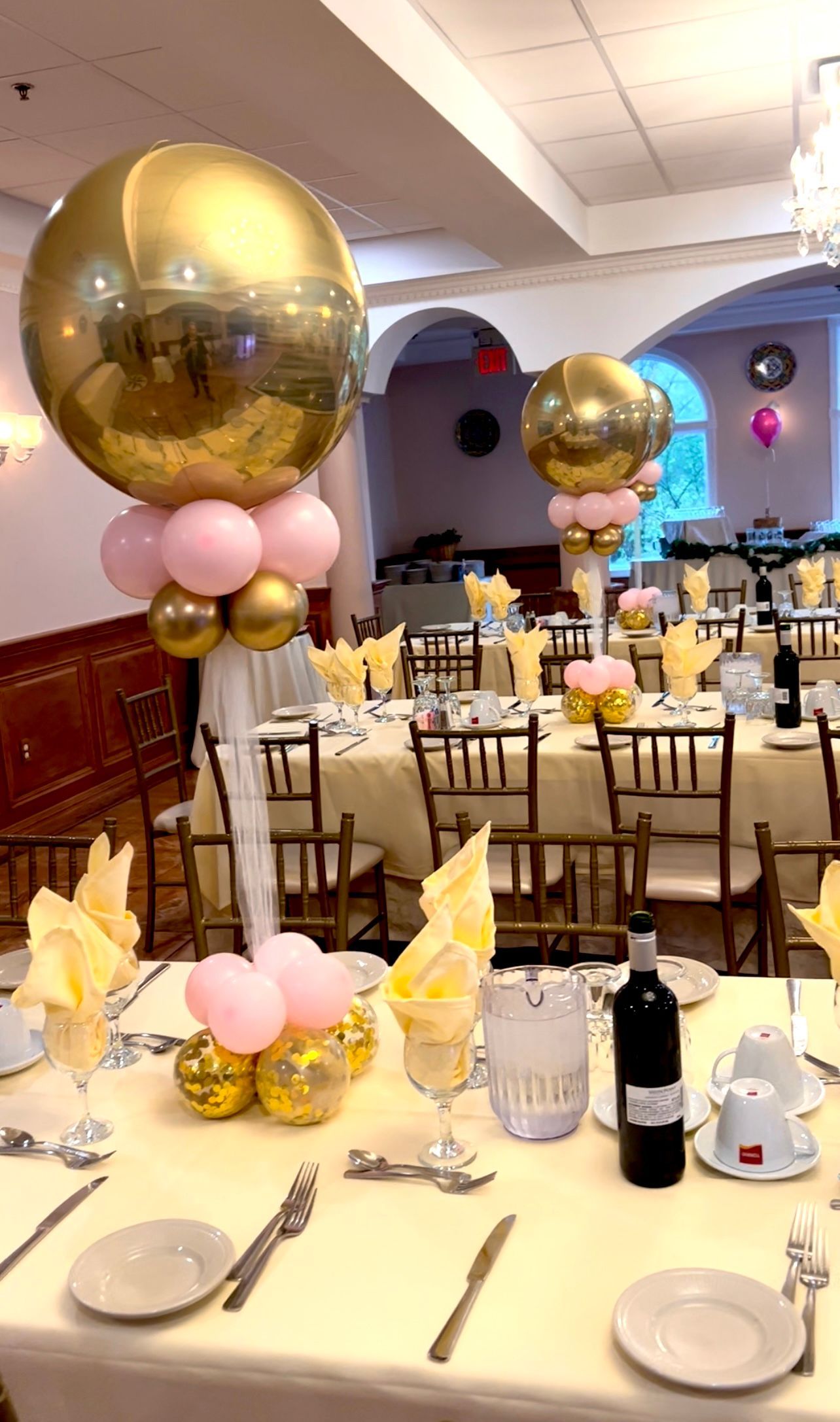 A table set for a party with balloons on it.