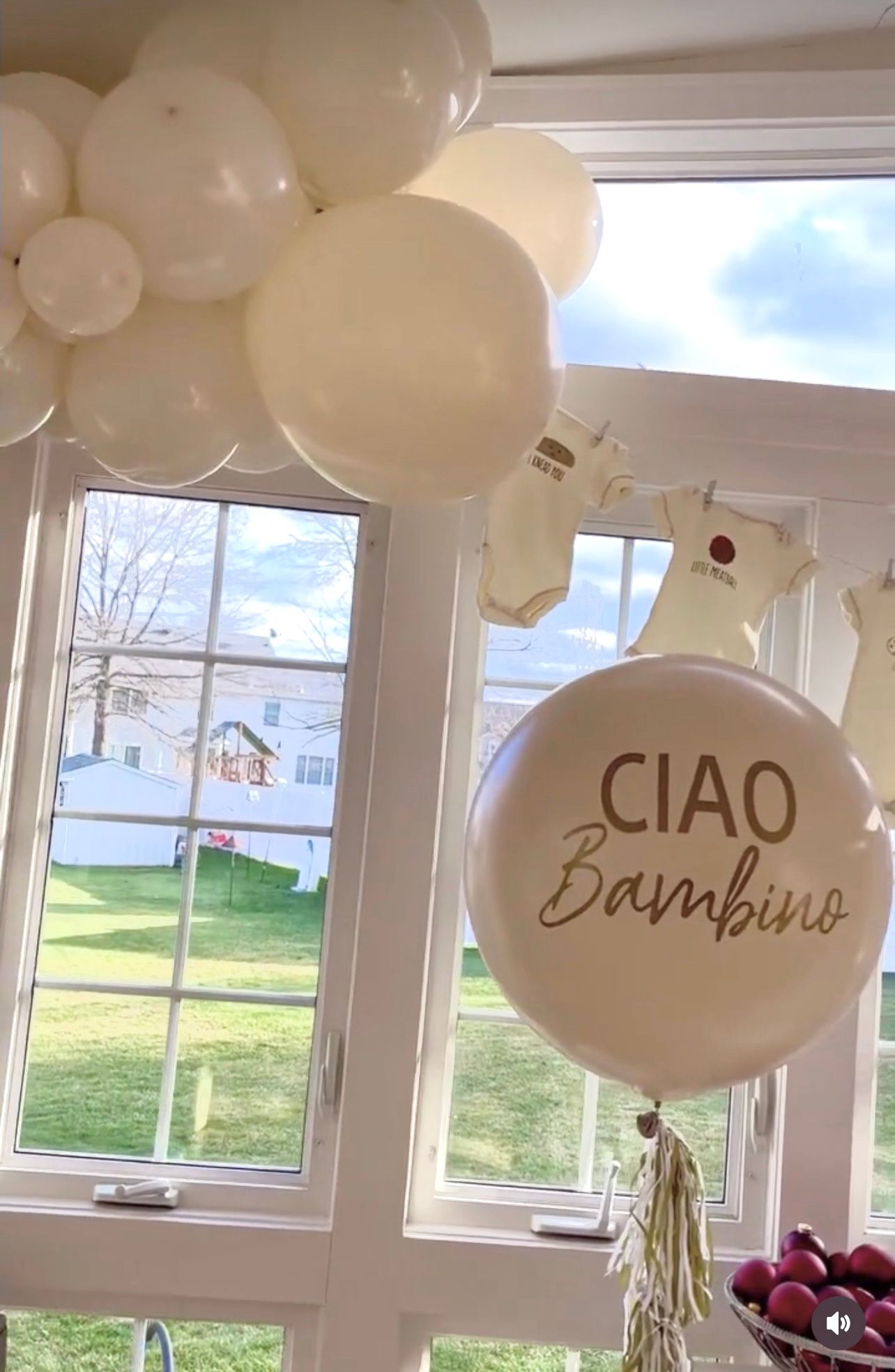 A bunch of balloons are hanging from the ceiling in a room.