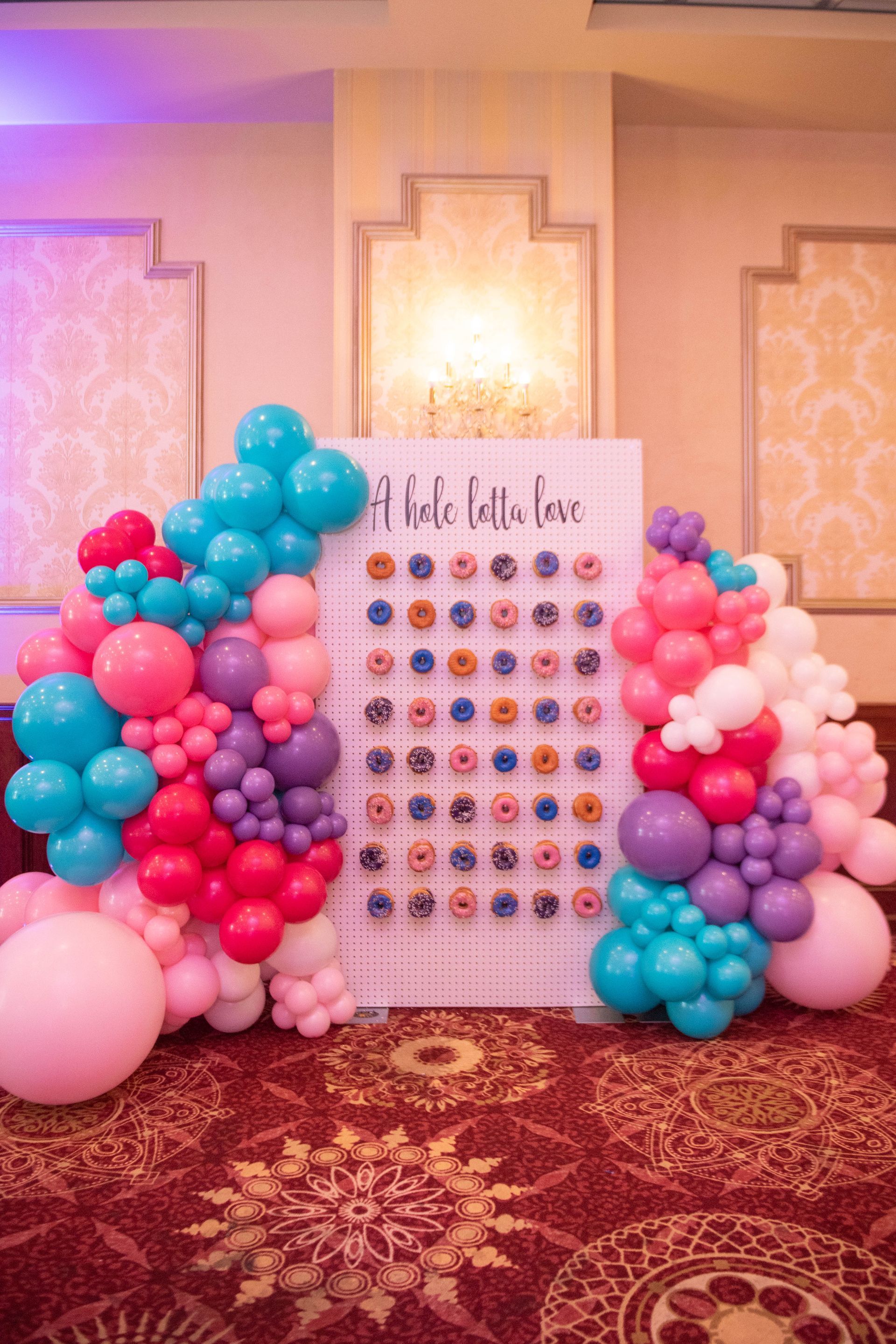 A room filled with balloons and a sign that says `` a little little love ''.