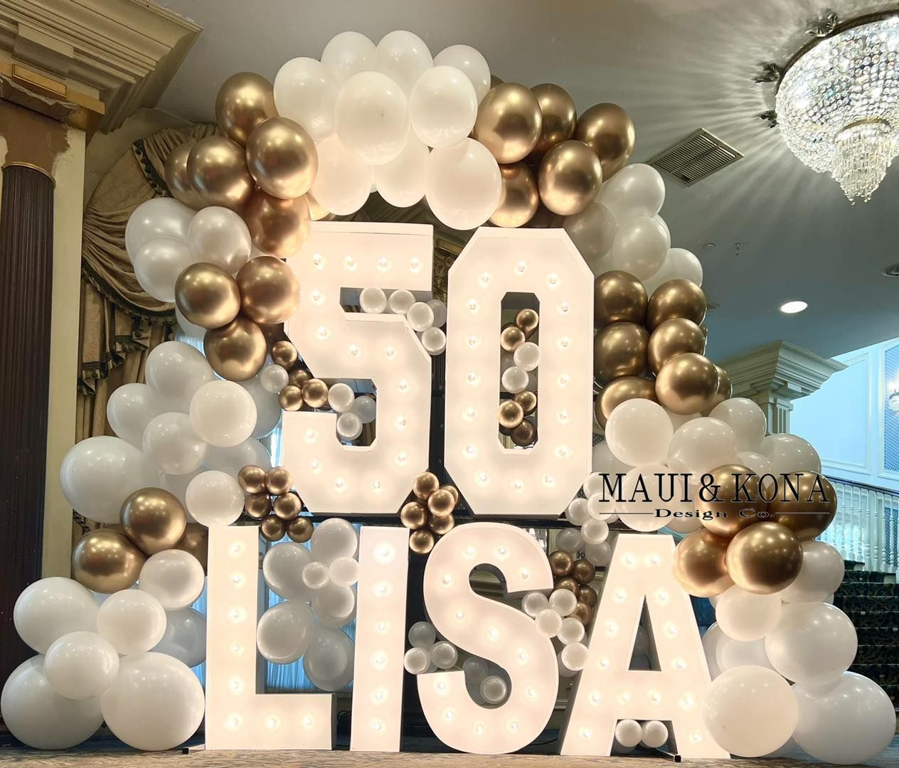 A large sign that says 50 lisa is surrounded by balloons.
