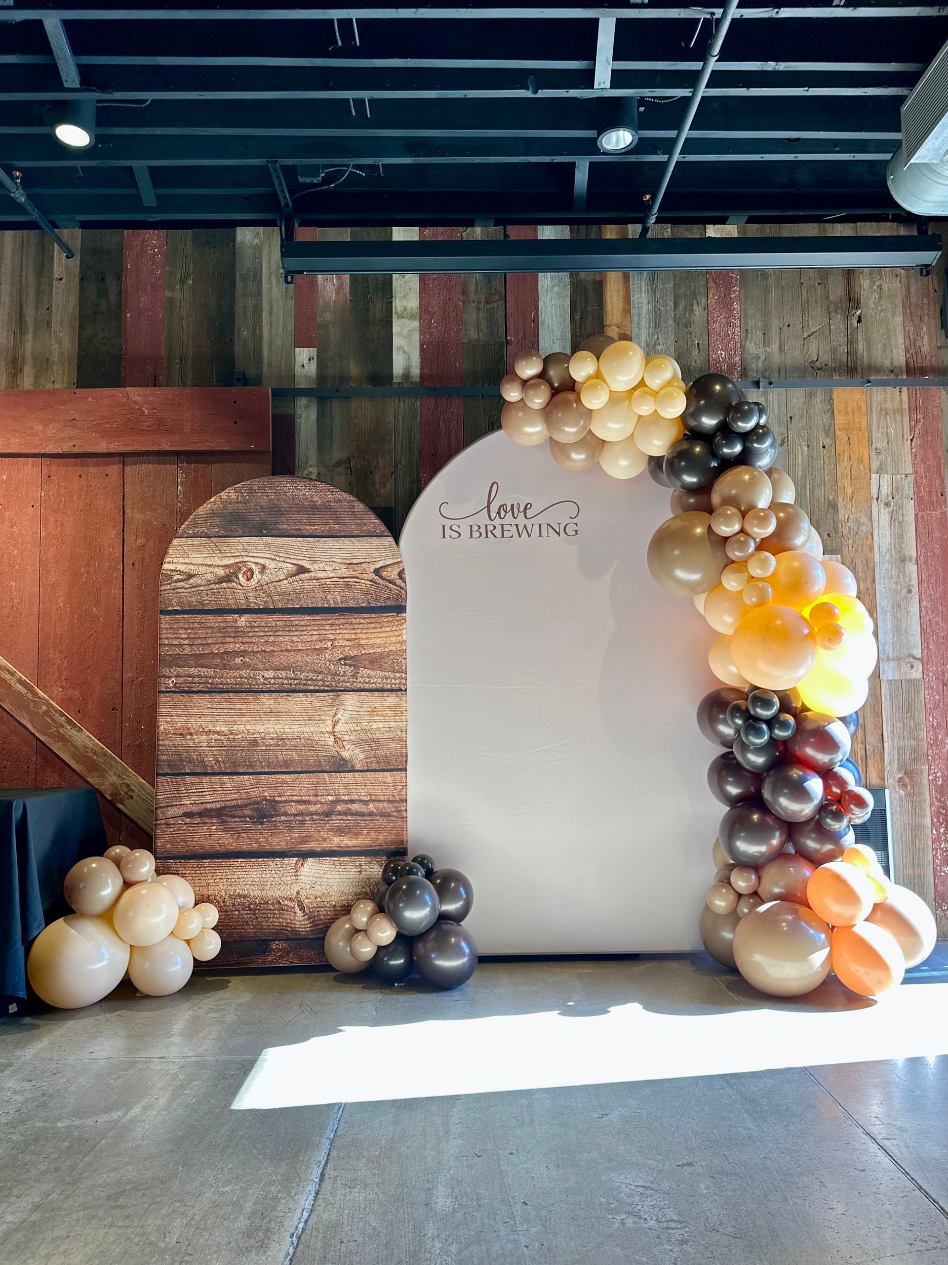 A room filled with balloons and a wooden wall.