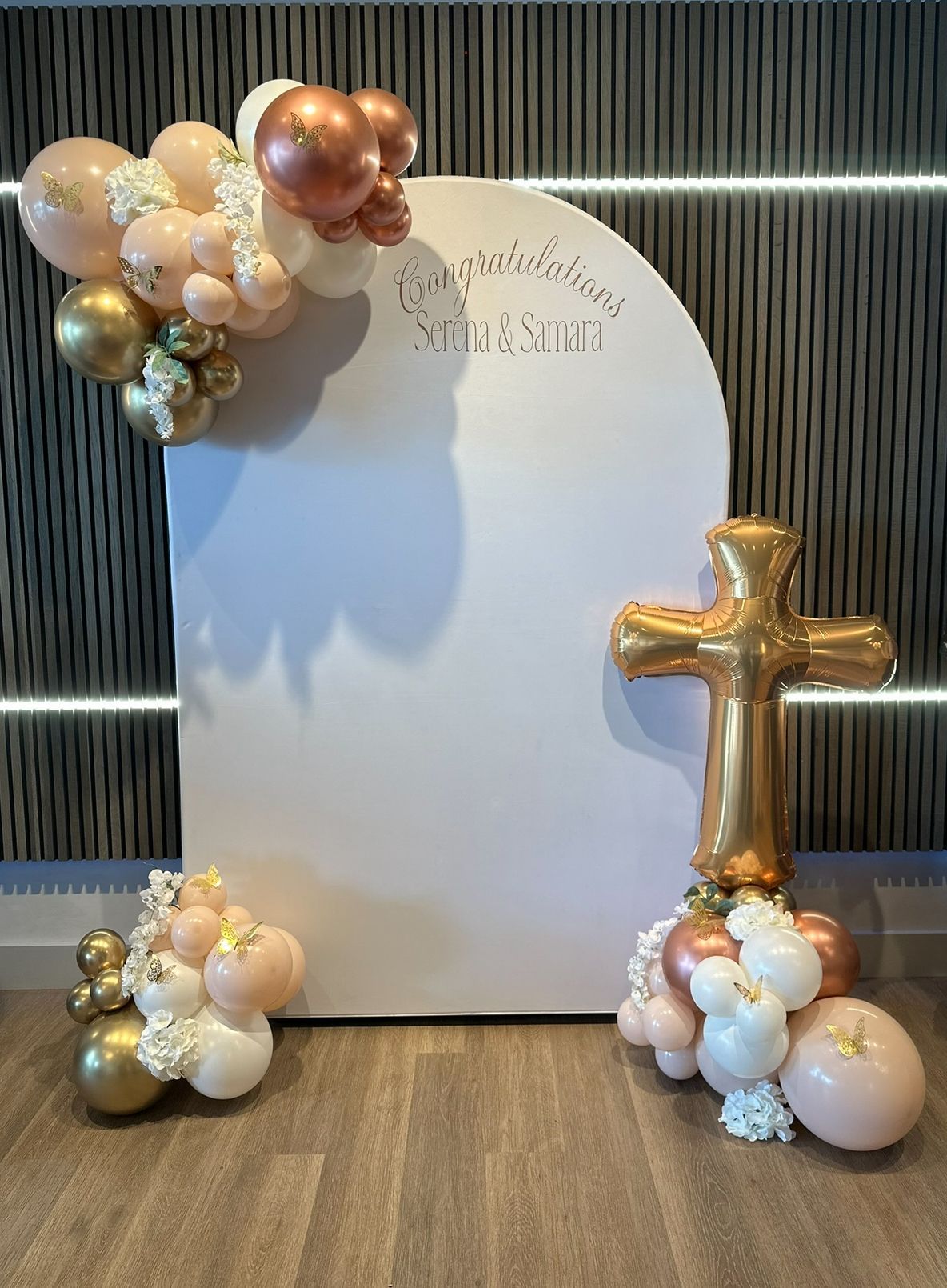 A white board with balloons and a cross on it.