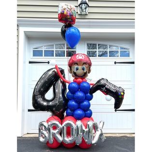 A mario balloon bouquet for a boy 's 4th birthday.