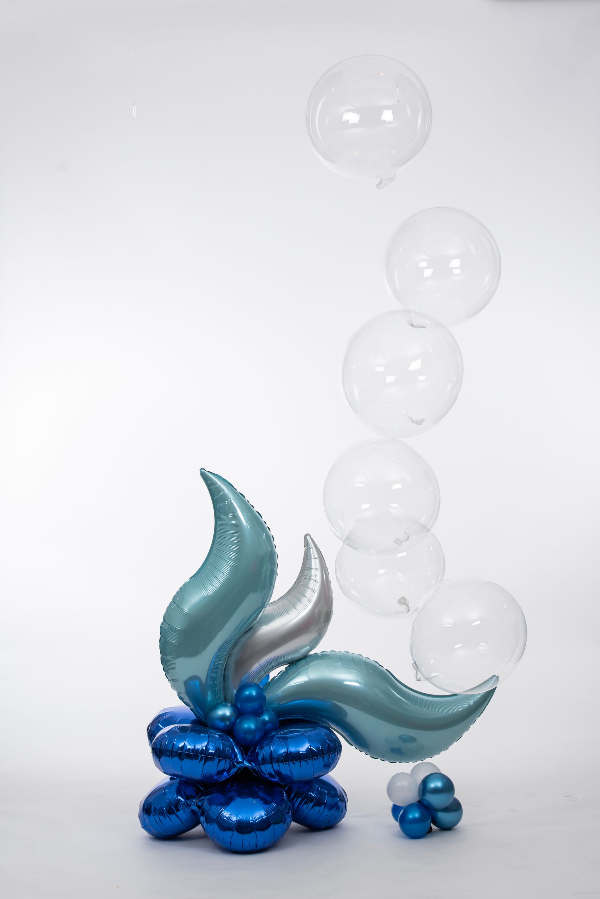 A bunch of balloons are sitting on top of each other on a table.