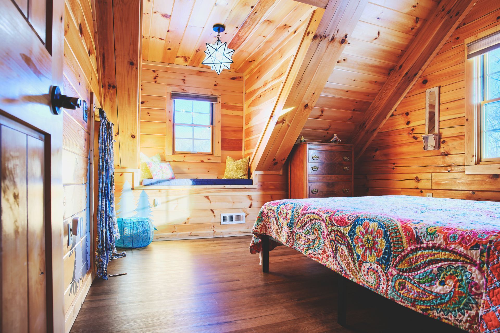 A bedroom in a log cabin with a bed and a window