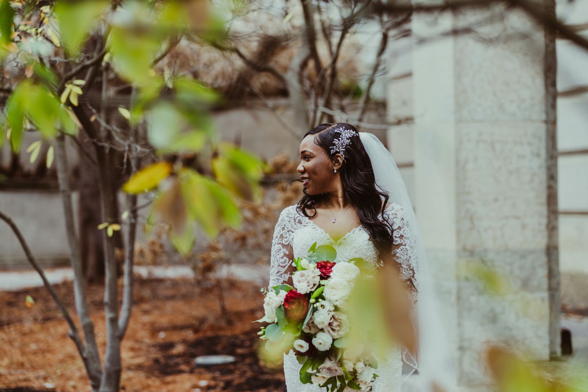 a bride in a wedding dress is holding a bouquet of flowers .