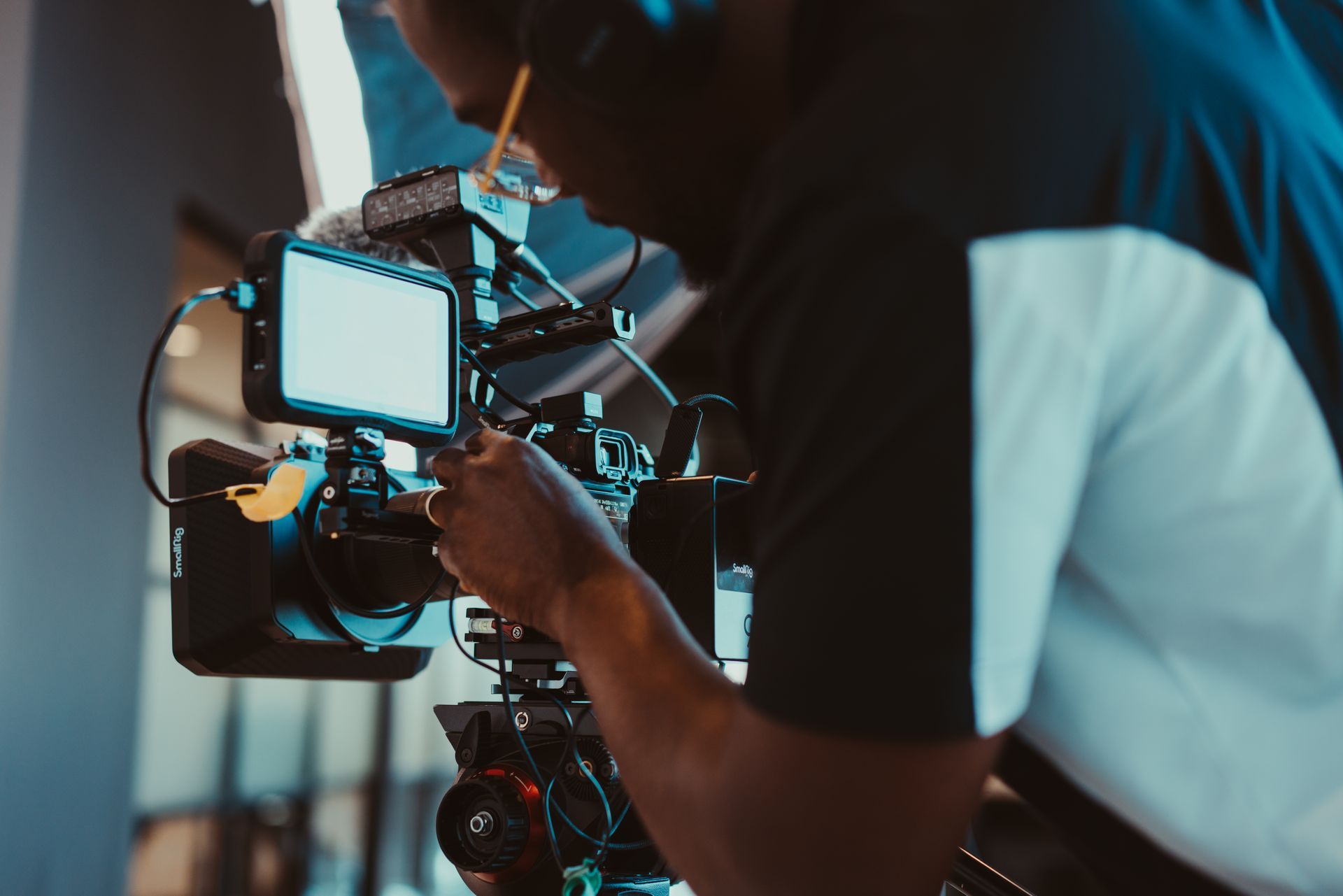 a man is working on a video camera in a dark room .