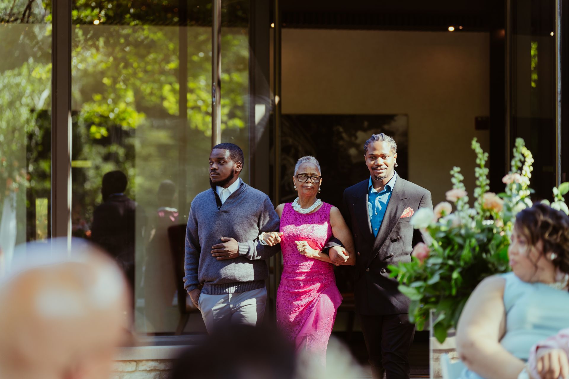 A group of people are walking down the aisle at a wedding.