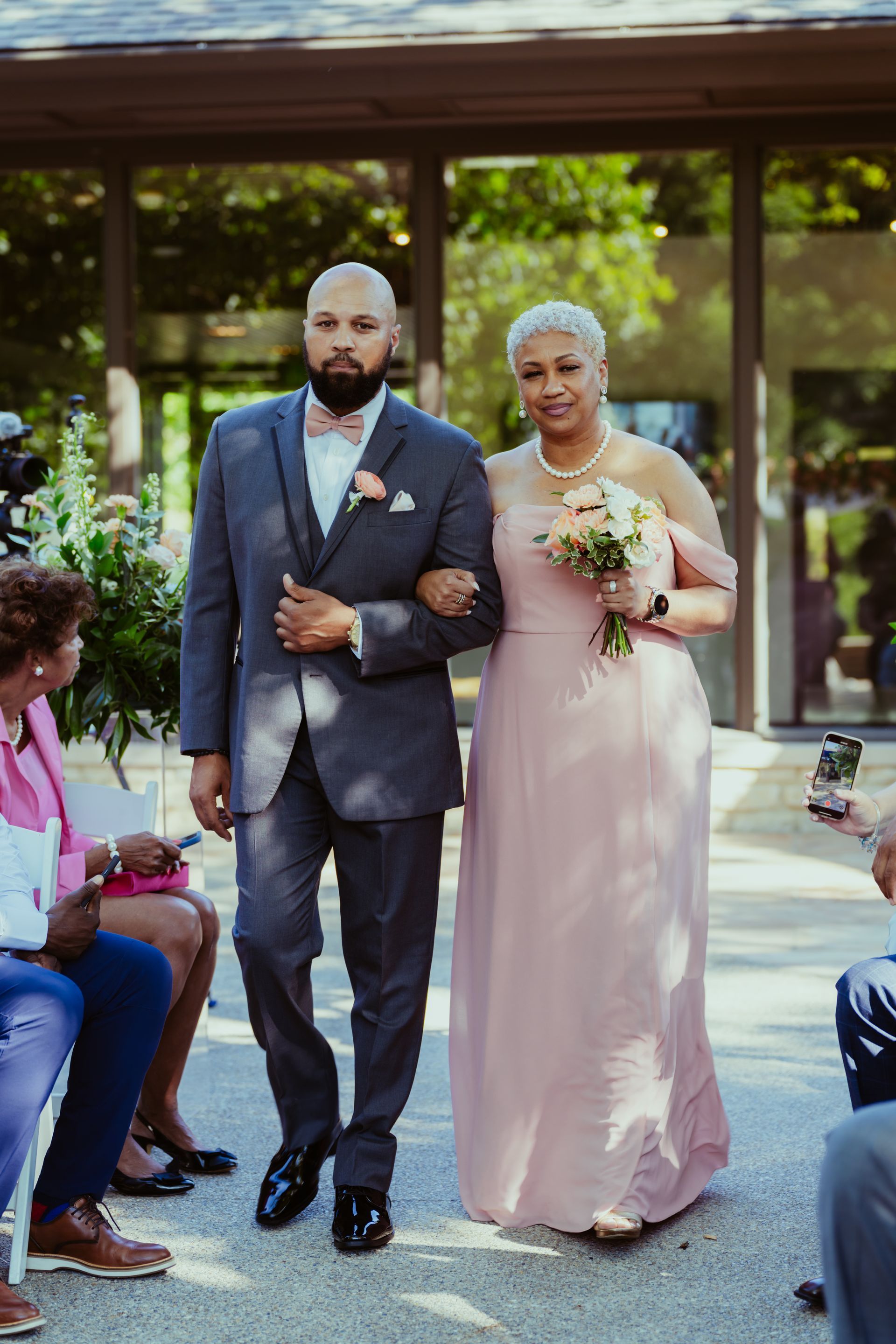 A bride and groom are walking down the aisle at a wedding.