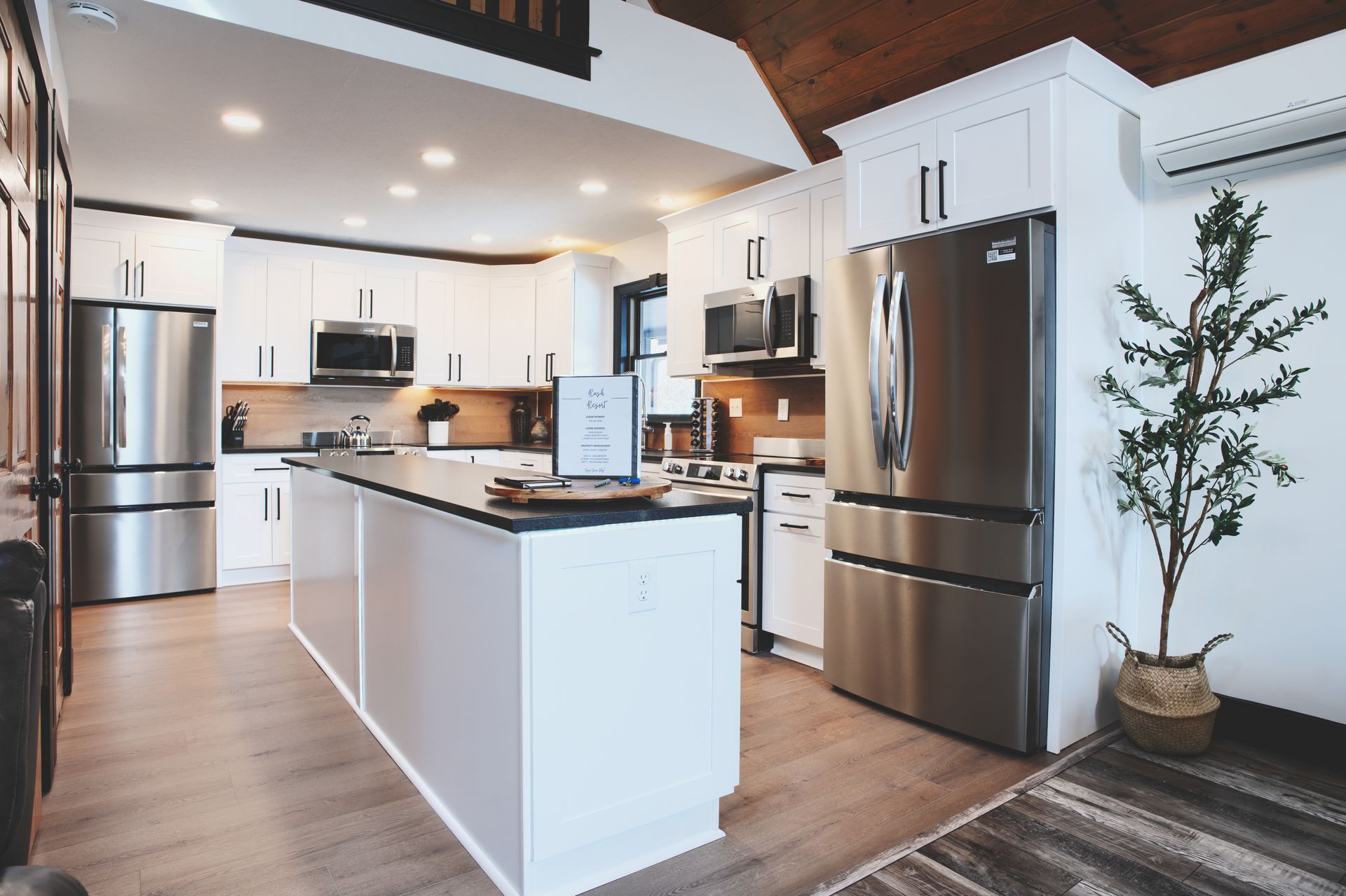 A kitchen with stainless steel appliances and white cabinets.