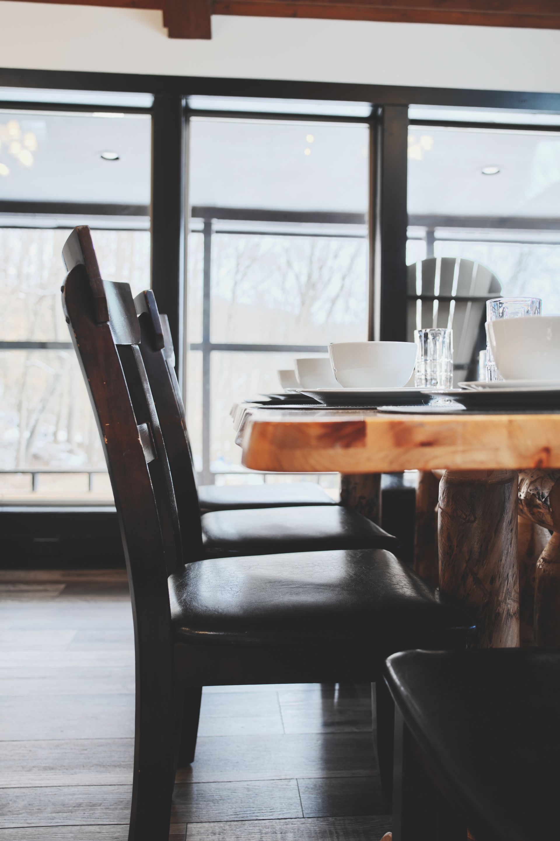 A dining room with a wooden table and chairs
