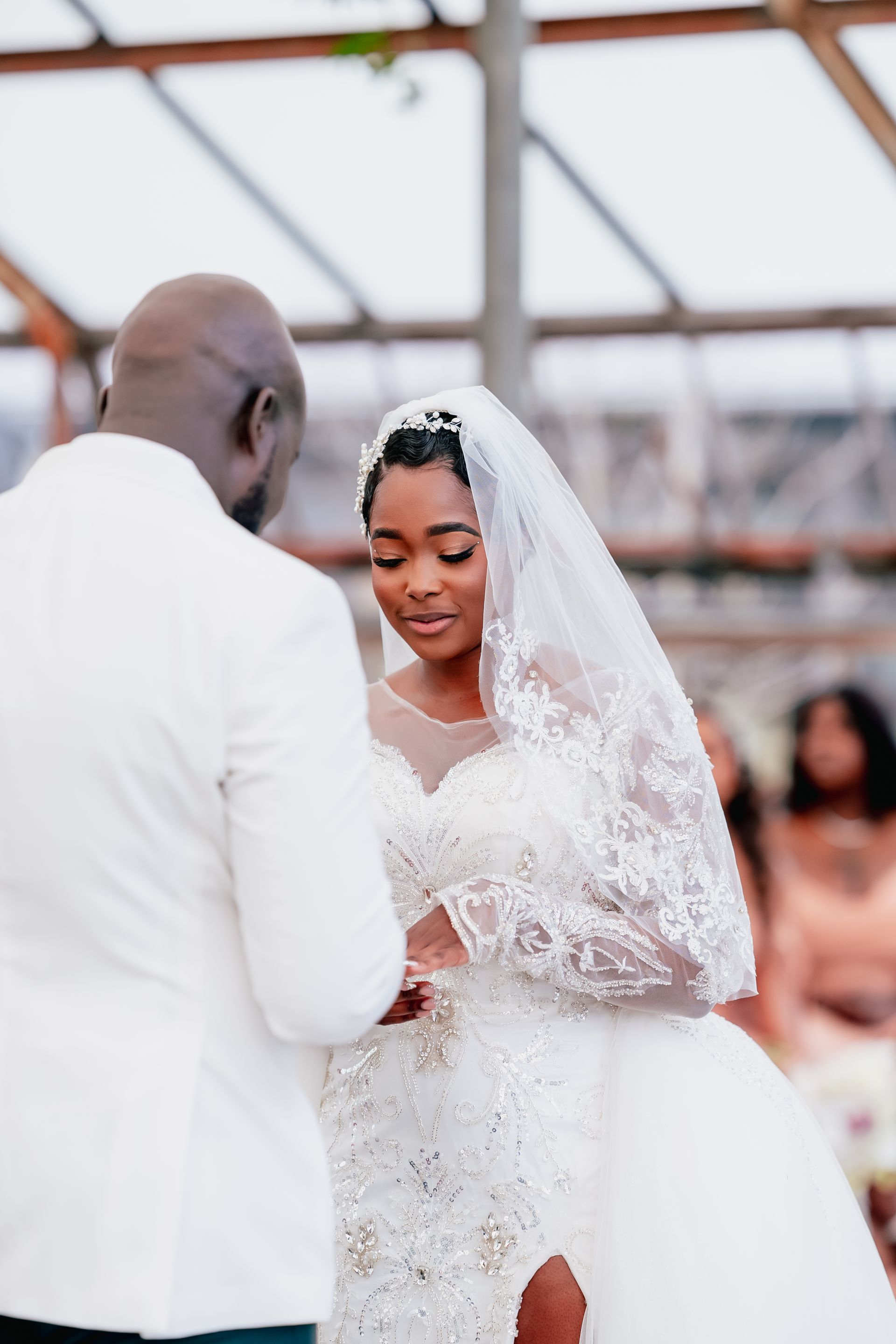 A bride and groom at their wedding wedding ceremony in a greenhouse.