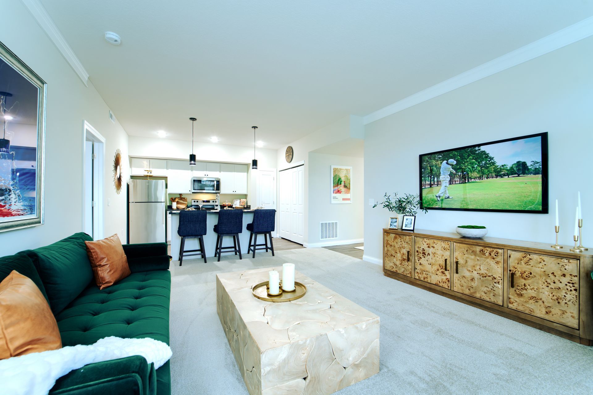 A living room with a green couch and a wooden coffee table