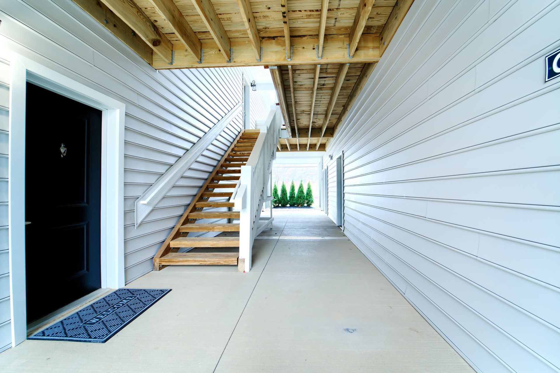 A hallway with stairs leading up to the second floor