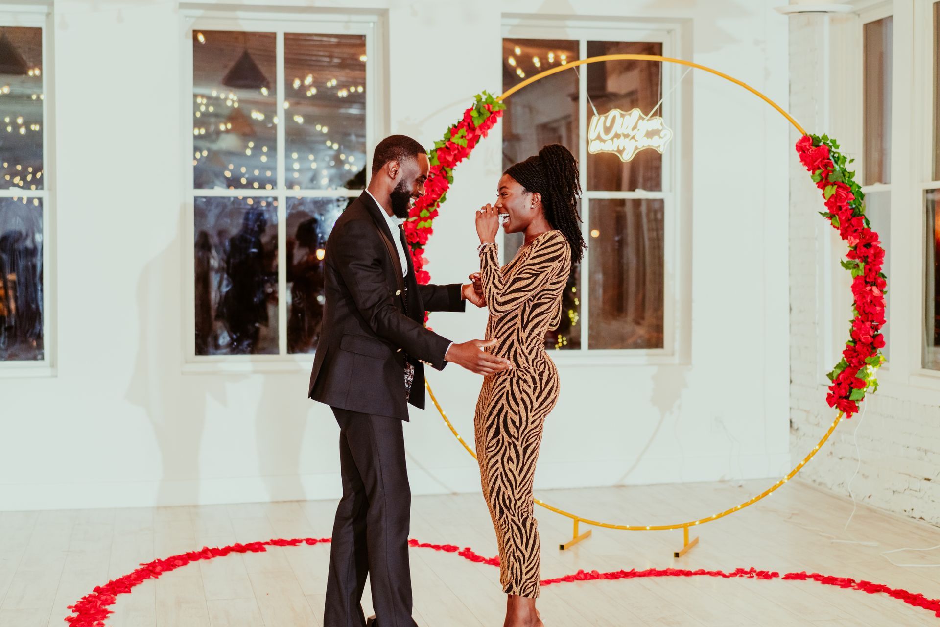 A man and a woman are standing next to each other in a room.