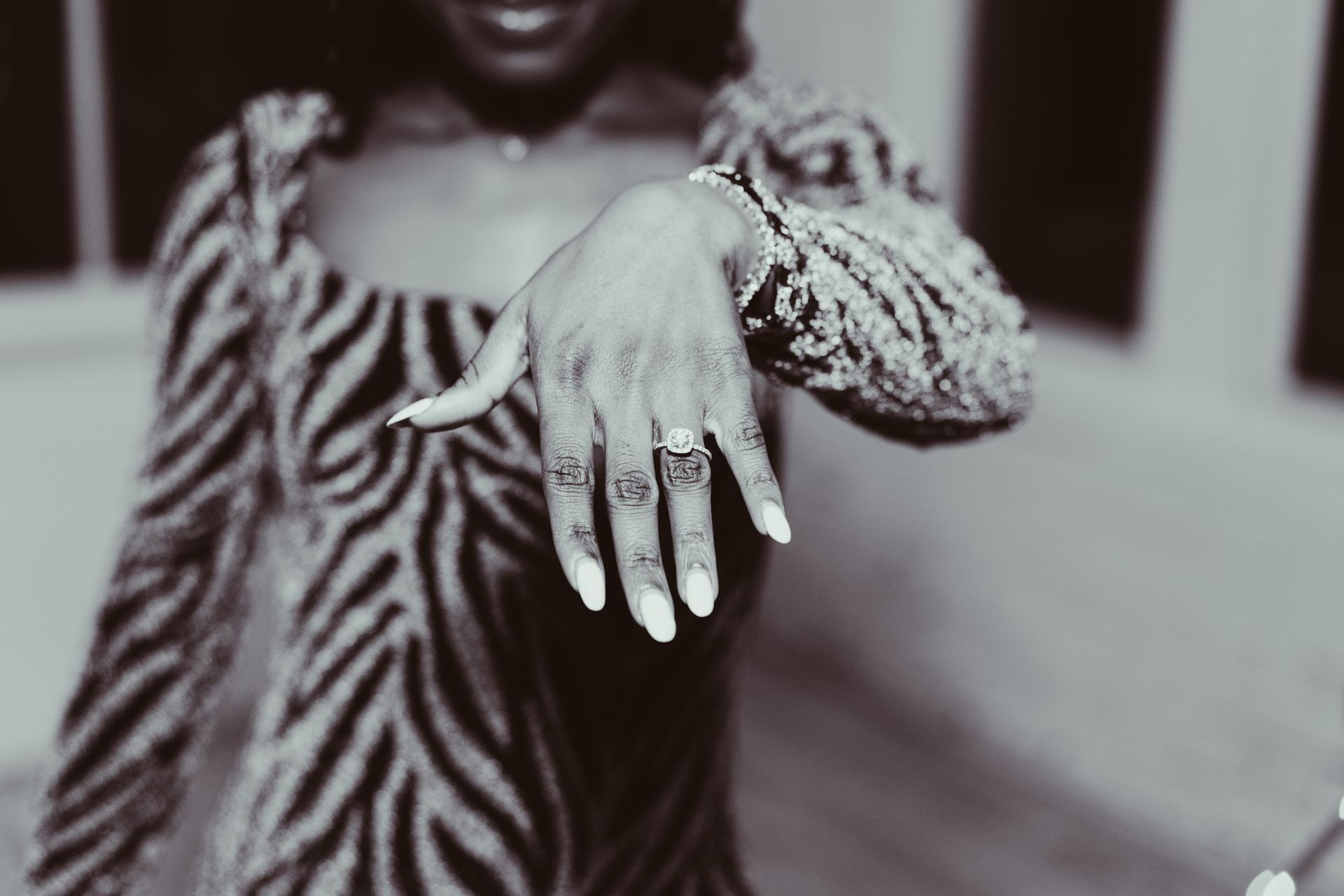 A woman in a zebra print dress is showing off her engagement ring.