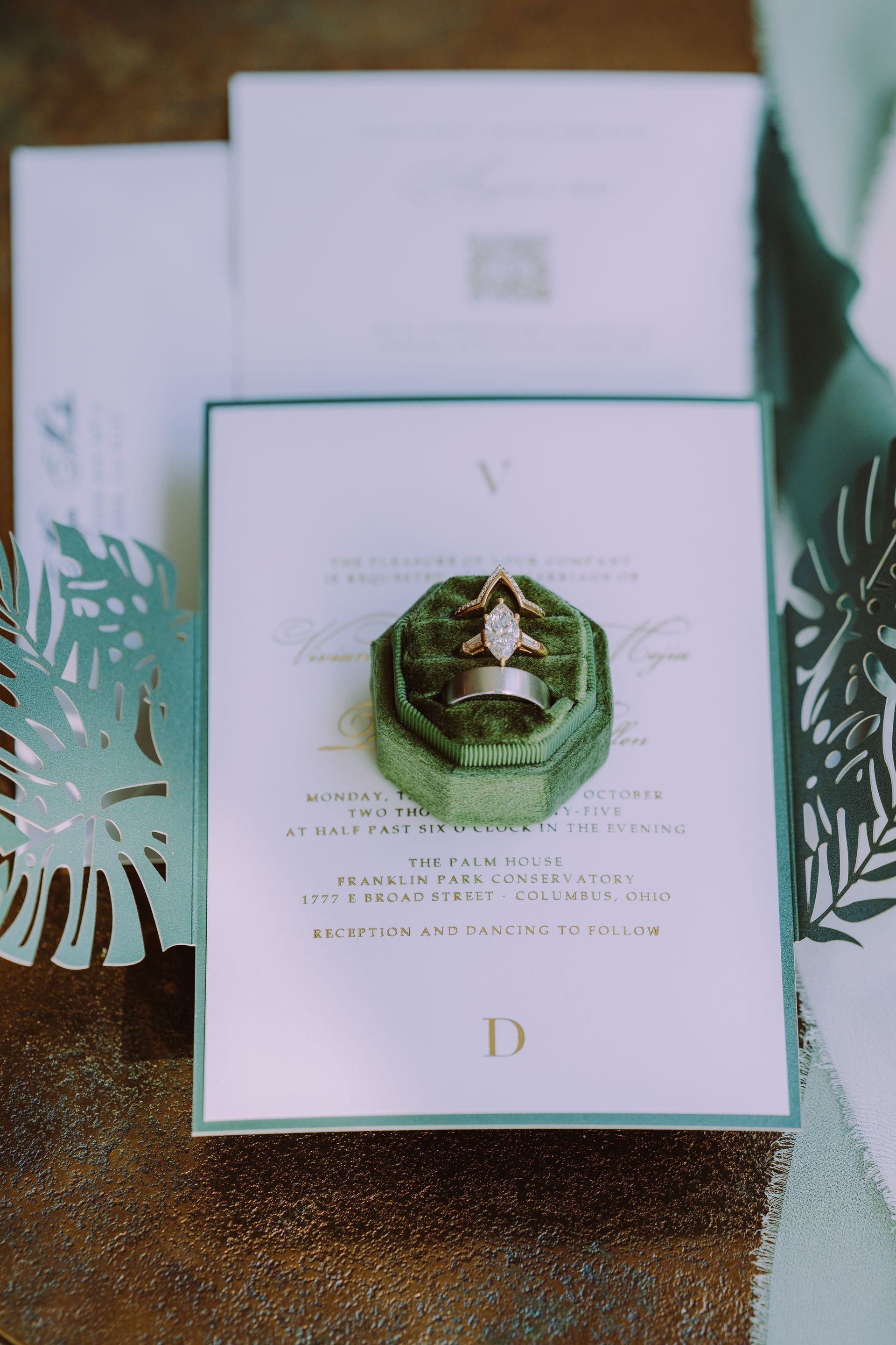 Wedding invitation with ring in a green velvet box.