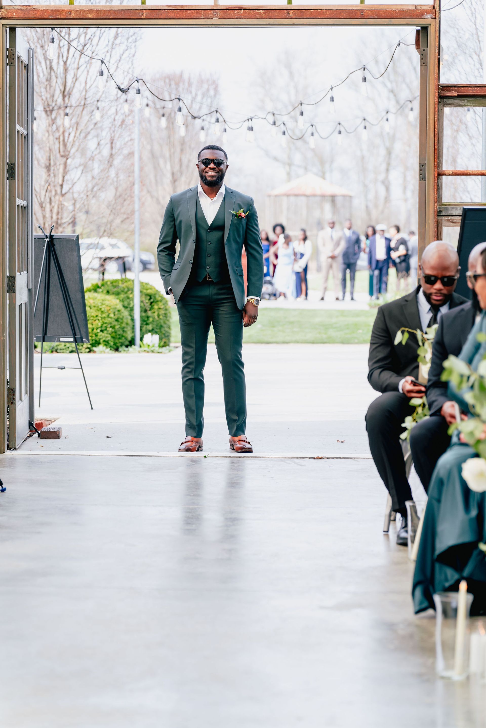 A man in a suit is walking down the aisle at a wedding.