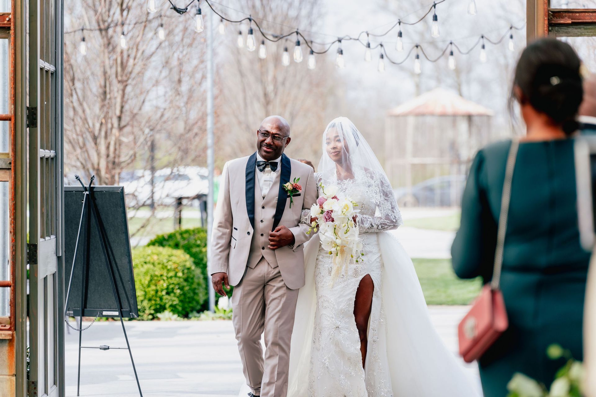 A bride and groom are walking down the aisle at their wedding.
