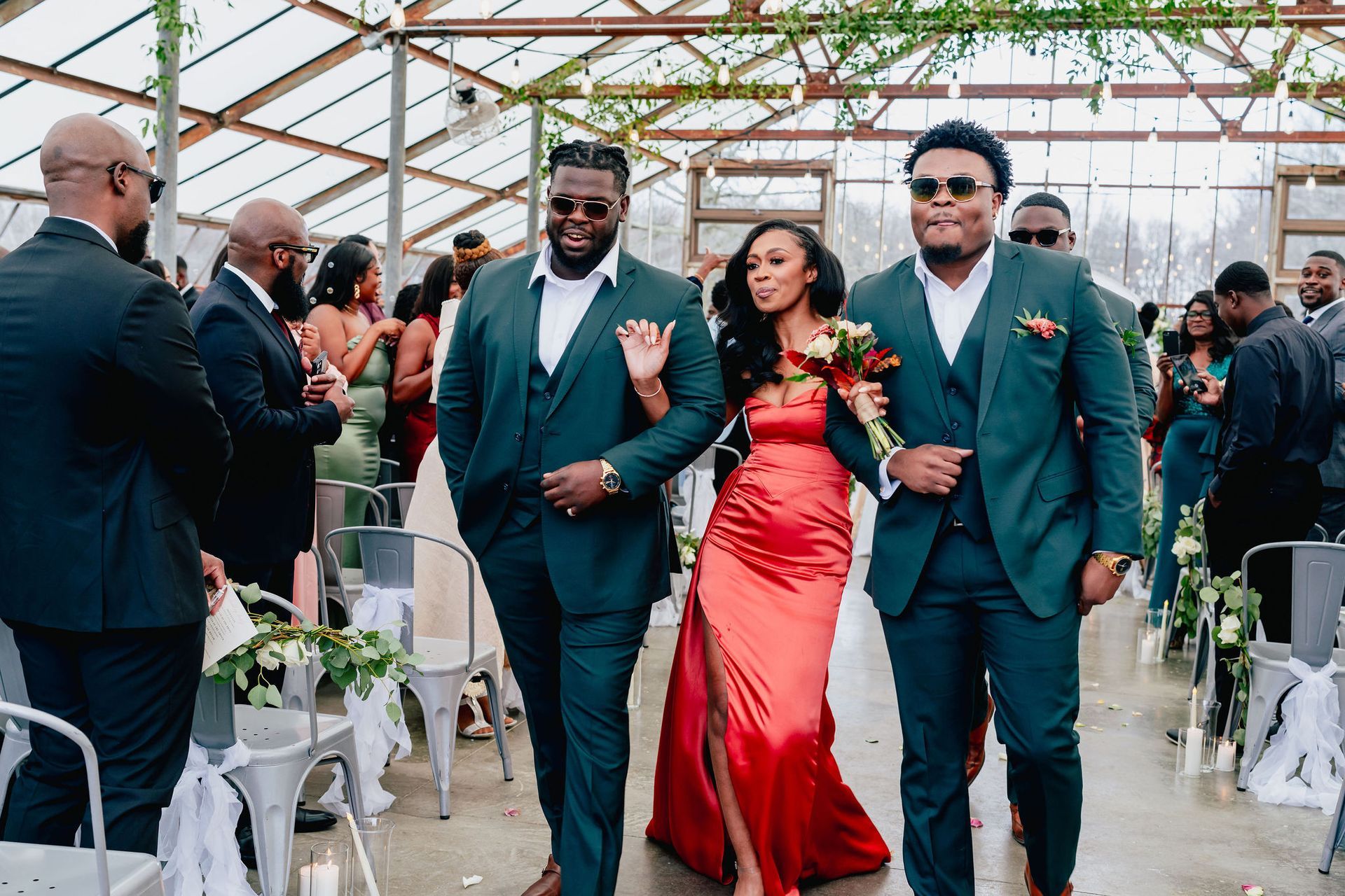 A bride and her groomsmen are walking down the aisle at a wedding.