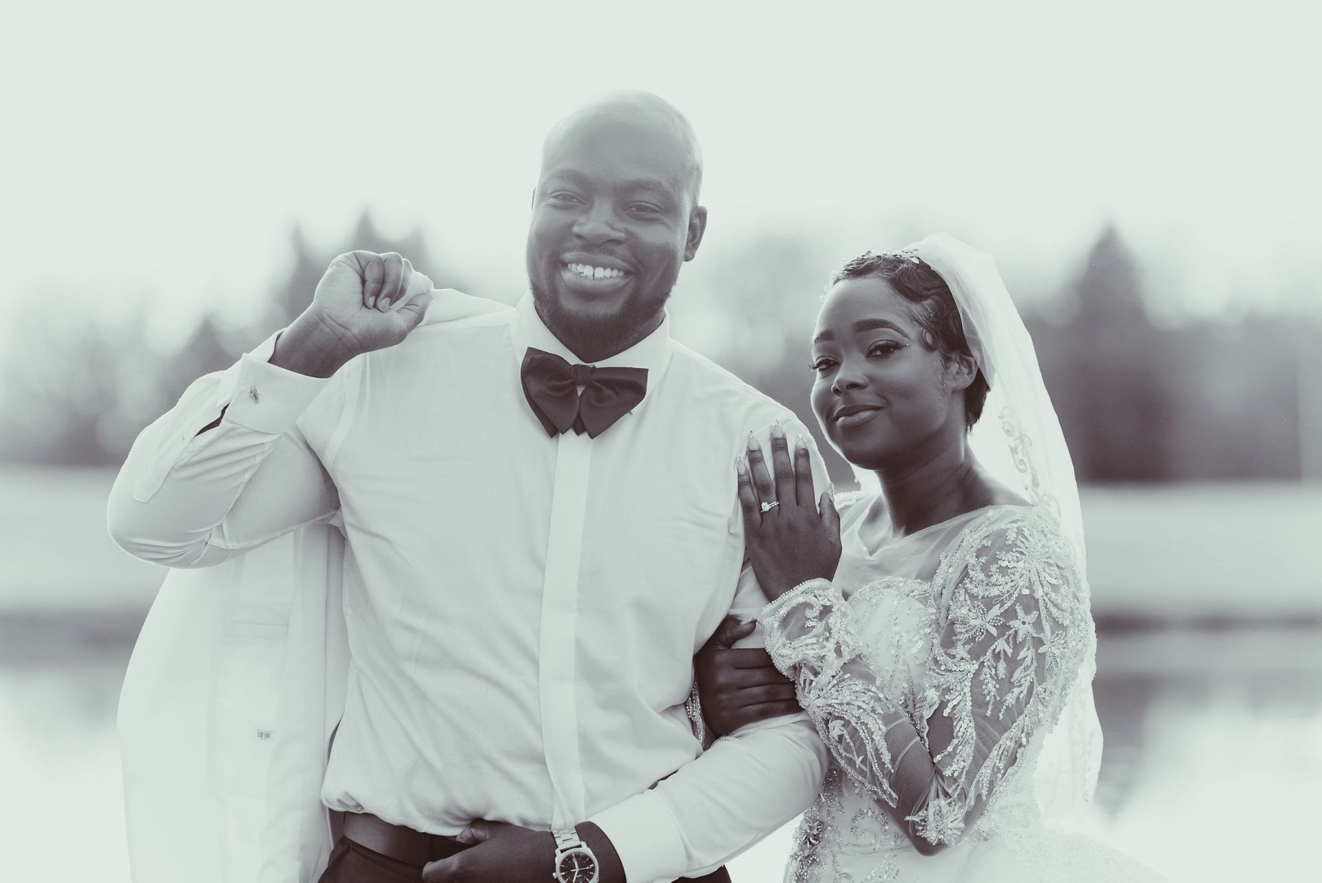 A black and white photo of a bride and groom posing for a picture.