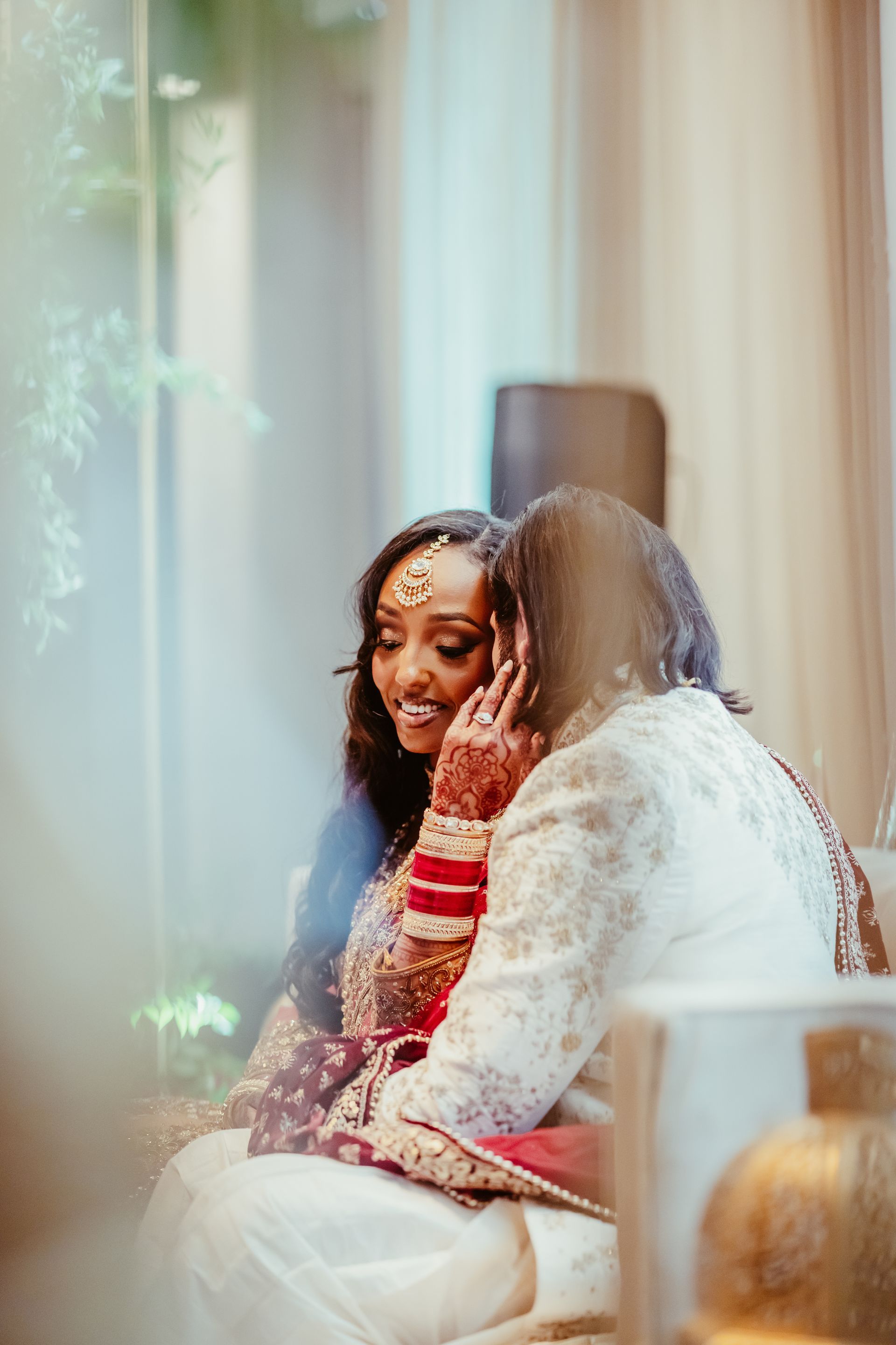 A bride and groom are sitting next to each other on a couch.