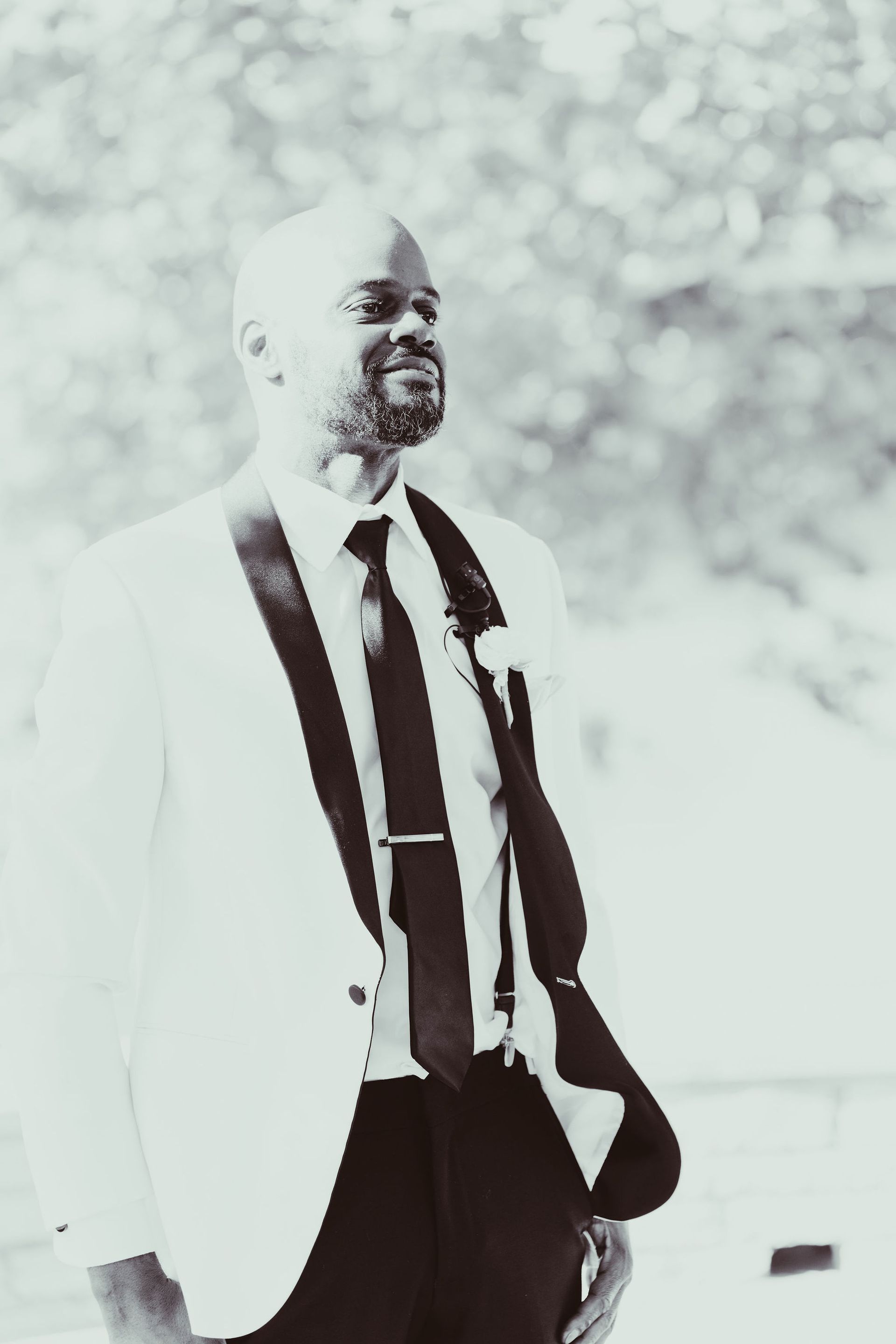A black and white photo of a man in a suit and tie