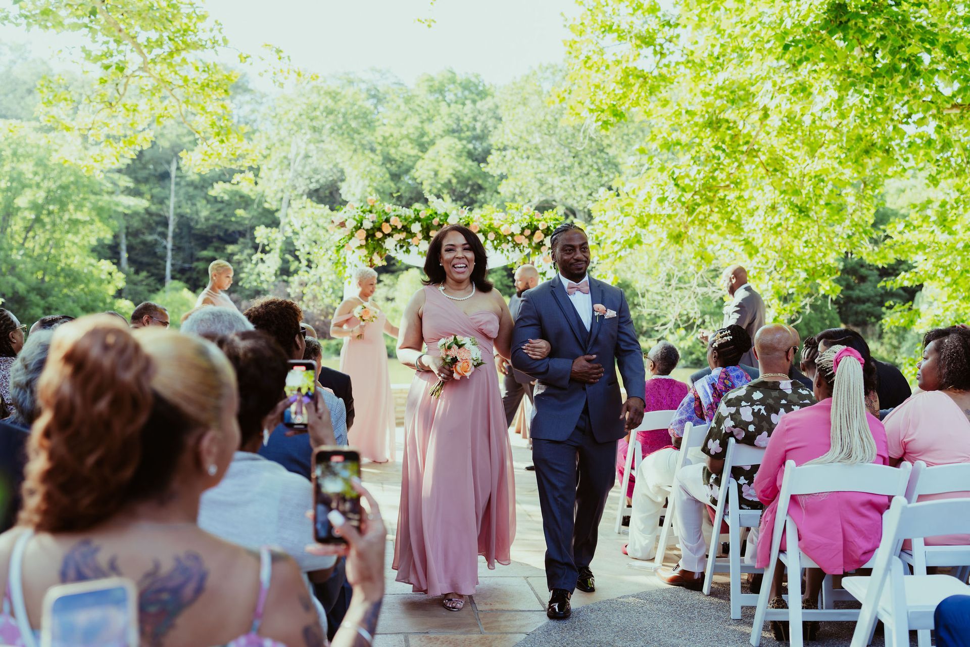 A bride and groom are walking down the aisle at their wedding.