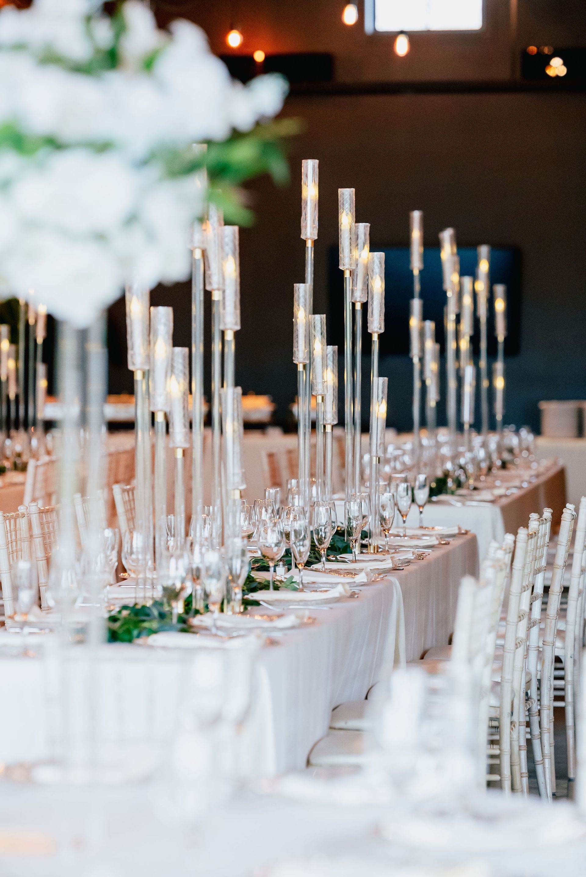 A long table with a lot of candles on it
