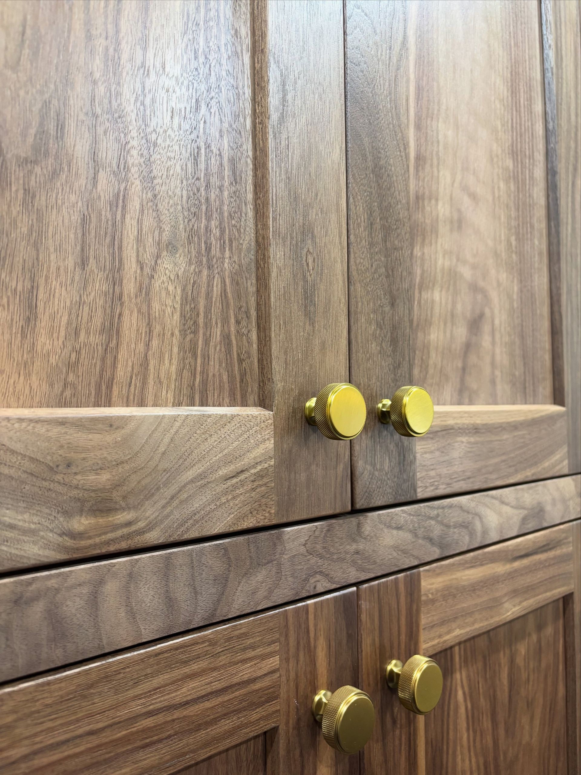 Wooden cabinets with gold knobs.
